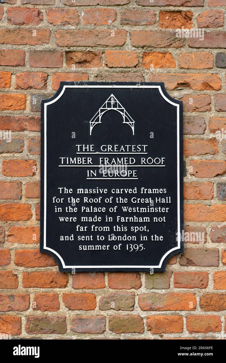 A heritage sign in the centre of Farnham stating that the beams for 'The Greatest Timber Framed Roof in Europe' were made in Farnham. England, UK Stock Photo