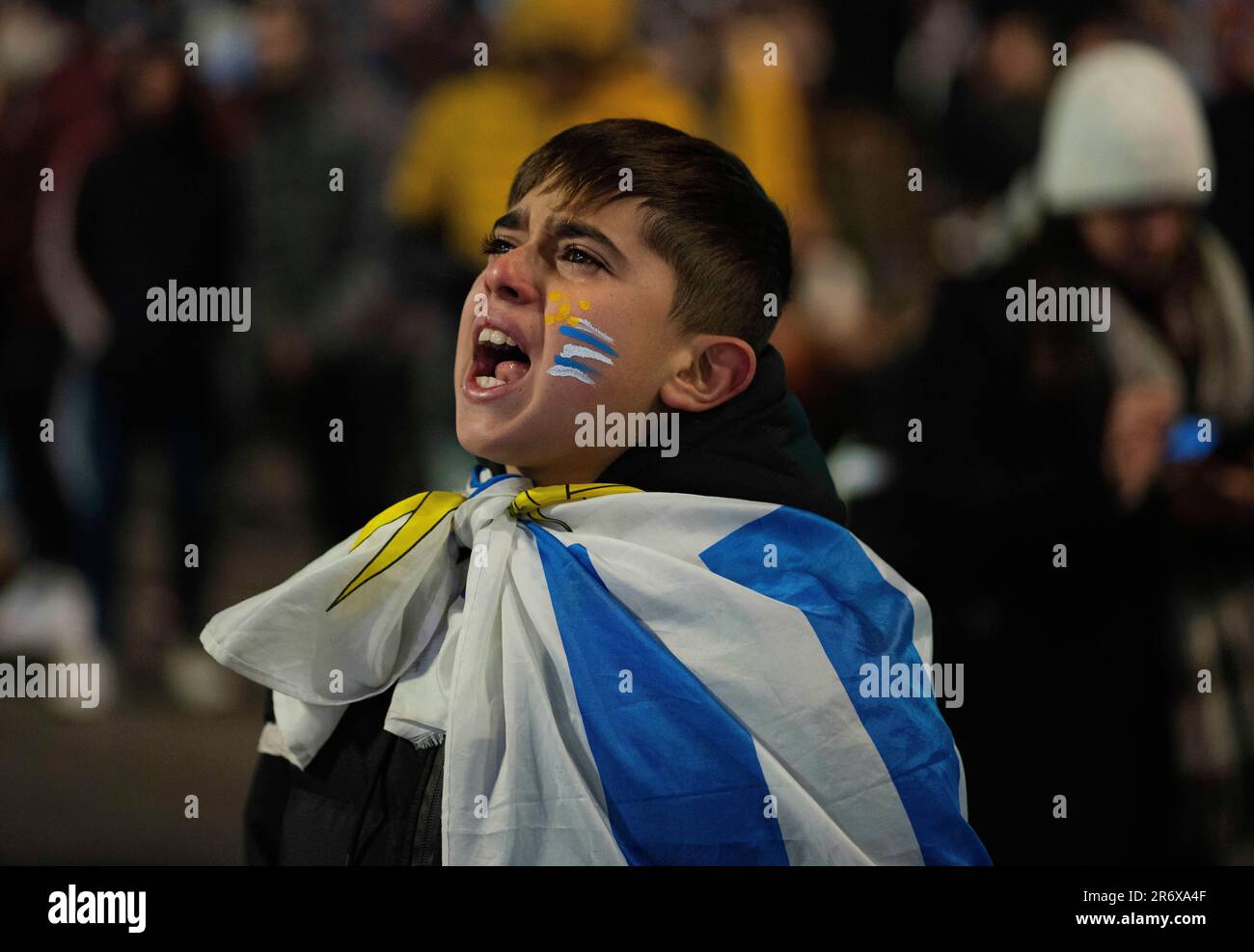 A boy reacts while watching the FIFA U-20 World Cup final soccer match between Uruguay and Italy, in downtown Montevideo, Uruguay, Sunday, June 11, 2023