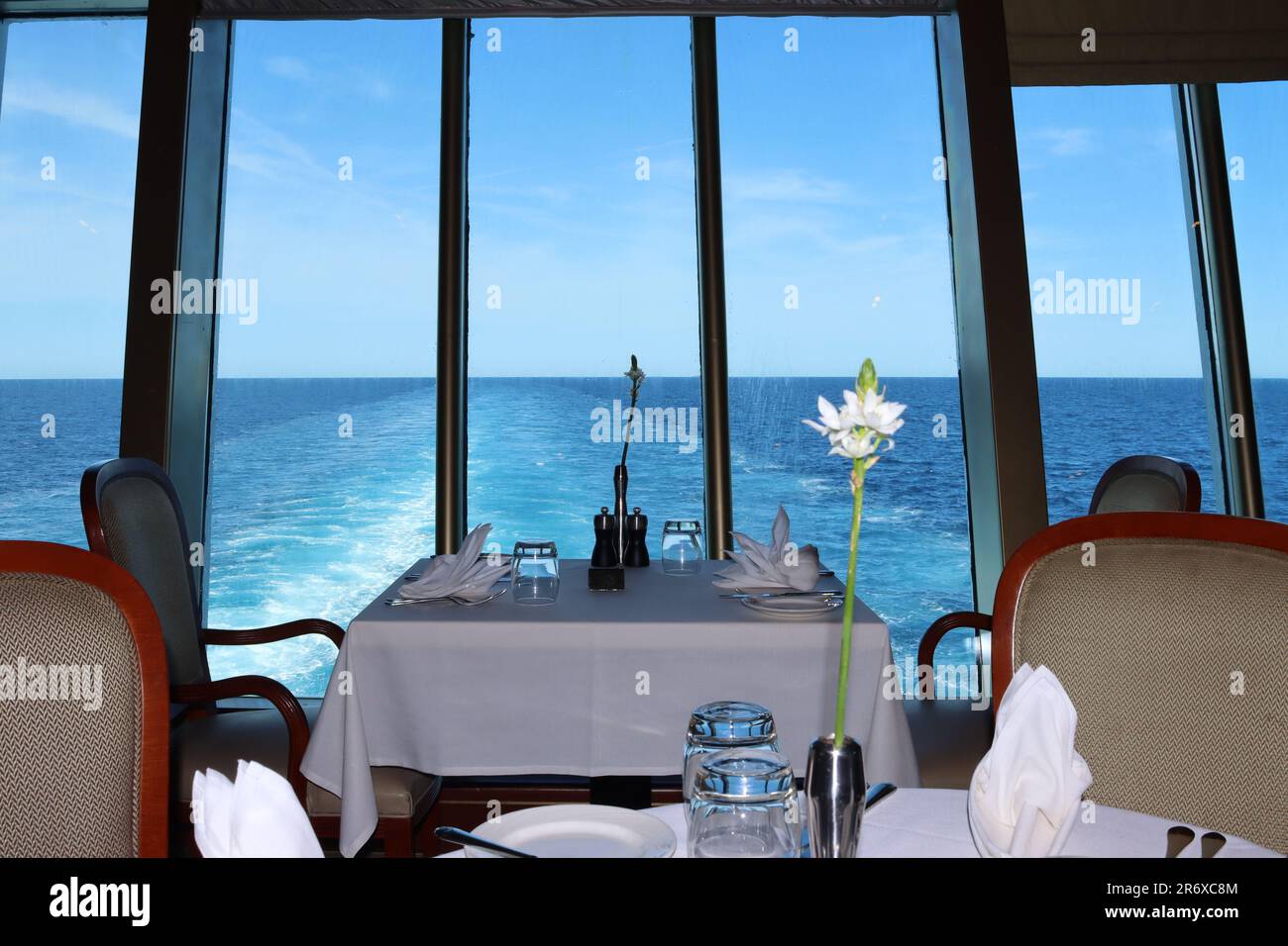 The best table in the Meridian restaurant MDR - Main Dining Room, looking astern aboard the P&O cruise ship Arcadia April 2023. Stock Photo