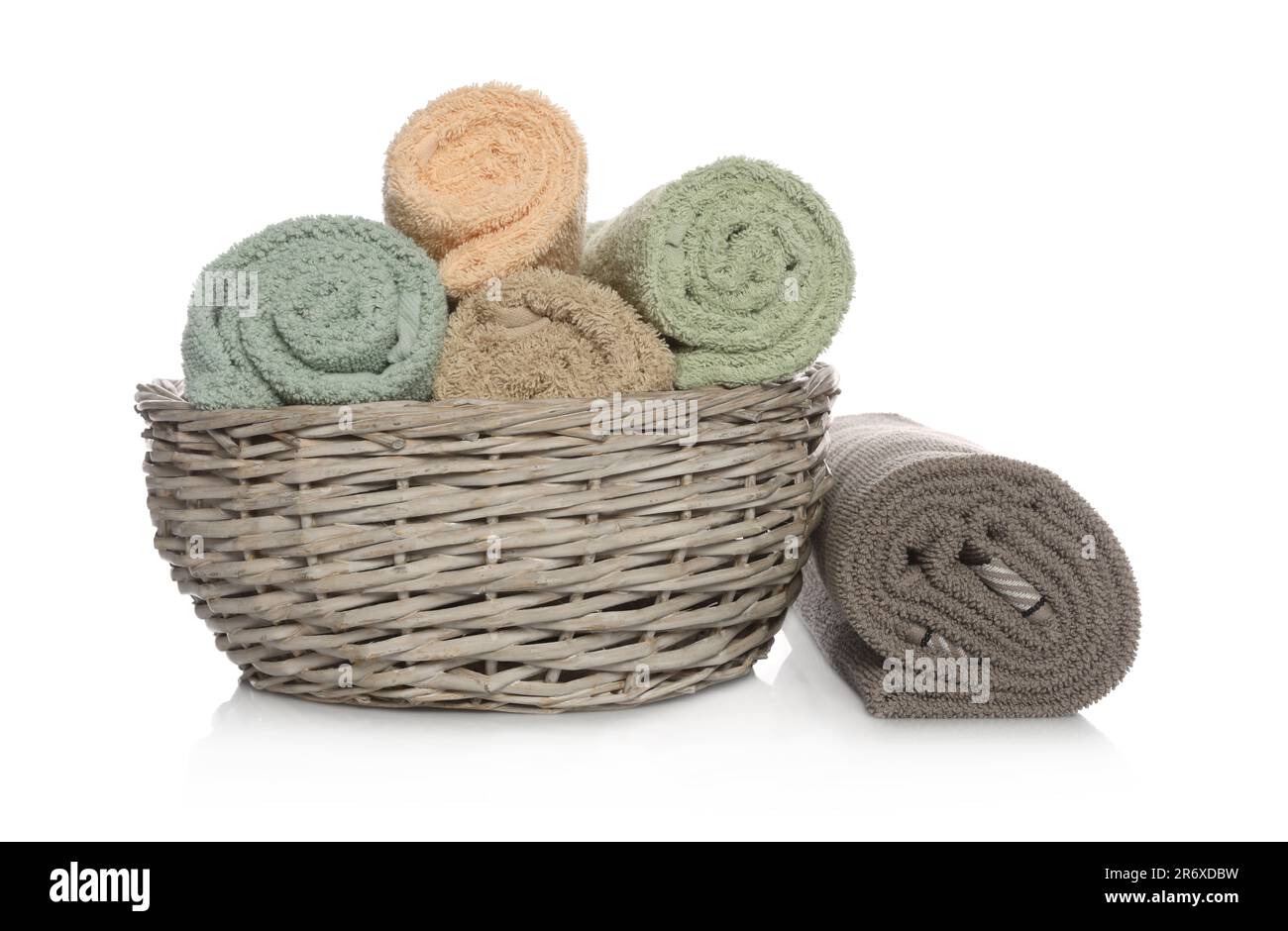 Wicker basket with rolled towels on white background Stock Photo Alamy