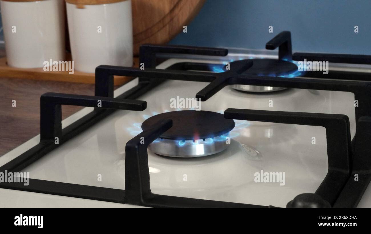 White gas cooktop with turned on burners in kitchen Stock Photo Alamy