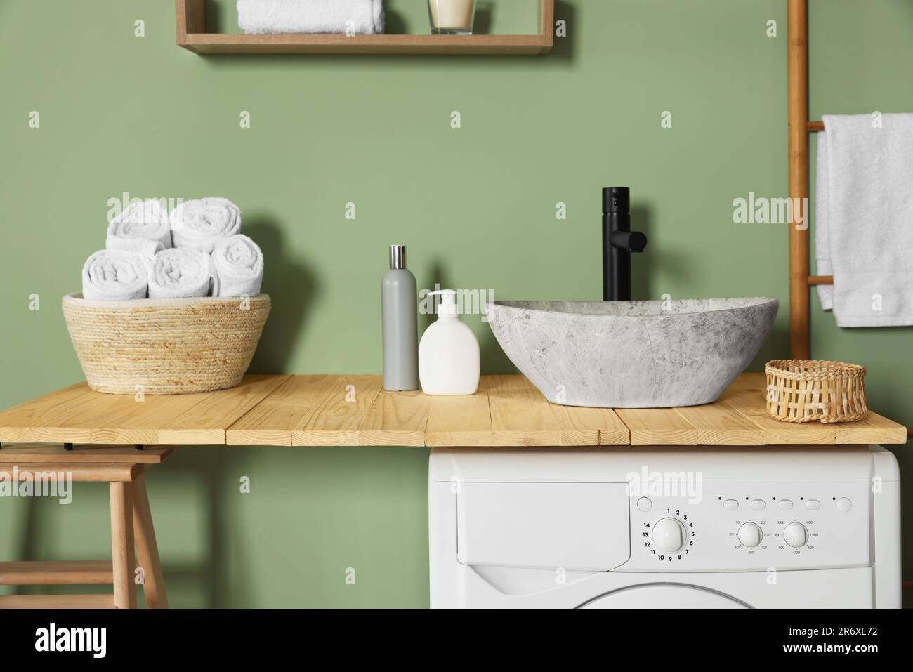 Wooden countertop on washing machine in laundry. Interior design Stock