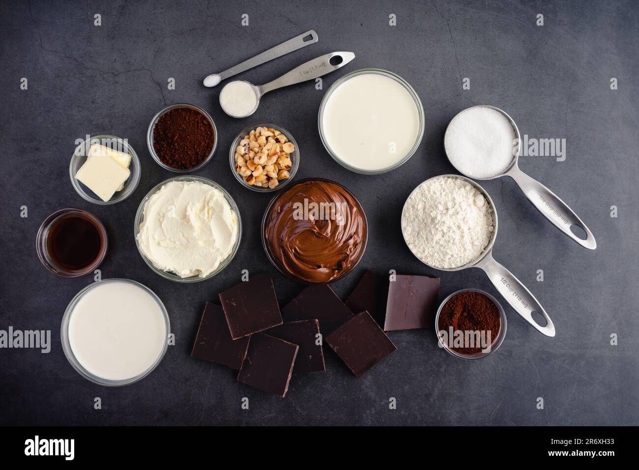 Hazelnut spread, dark chocolate, cream, and other cake ingredients Stock Photo