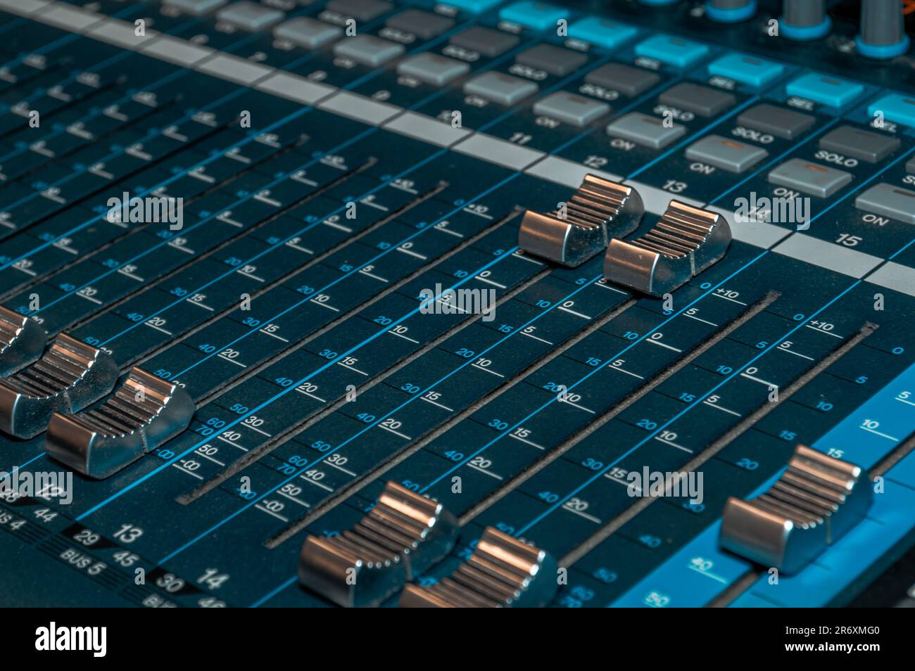 A close-up of a small analogue audio mixing console. Stock Photo