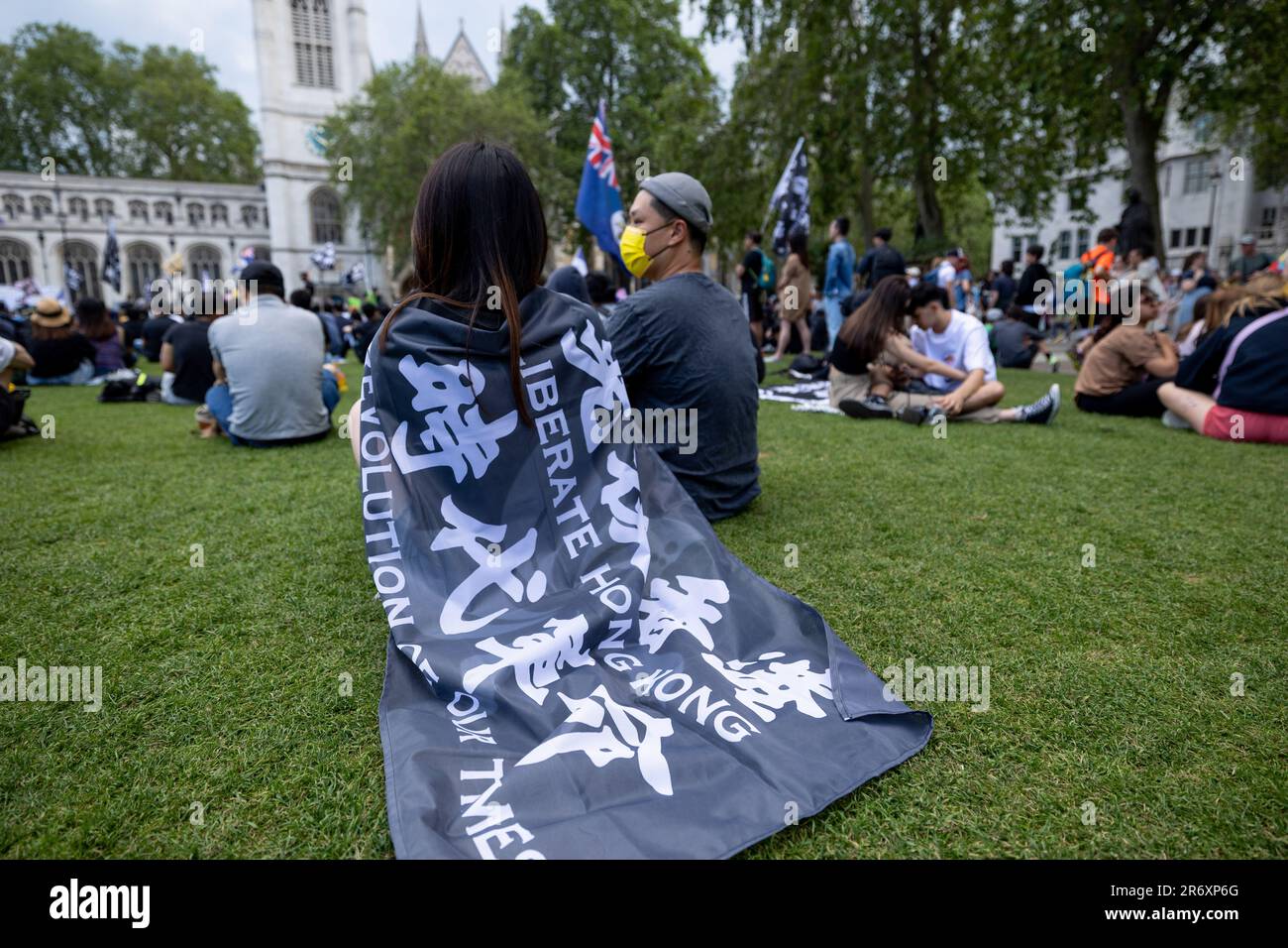 London, UK. 11th June, 2023. A protester is seen using a pro Hong Kong democracy flag as a cape during the rally. Hongkongers in London gathered at Parliament Square on the 4th year anniversary of the Hong Kong pro-democratic movement. Credit: SOPA Images Limited/Alamy Live News Stock Photo
