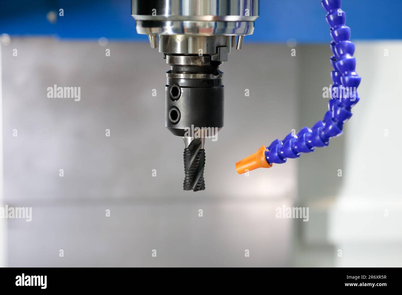 CNC milling machine spindle with roughing end mill cutter. Selective focus. Stock Photo