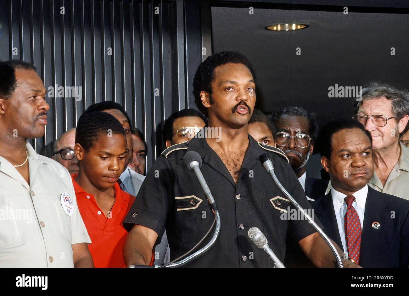 DULLES, VIRGINIA - JUNE 28, 1984The Reverend Jesse Jackson flanked by DC Mayor Marion Barry (L) and Delegate Walter Faunroy (D-DC) (R) speaking at news conference inside Dulles International Airport shortly after landing on his return from Havana, Cuba with freed American and Cuban prisoners said that he was convinced peace was possible in Central America. Credit: Mark Reinstein /  MediaPunch Stock Photo