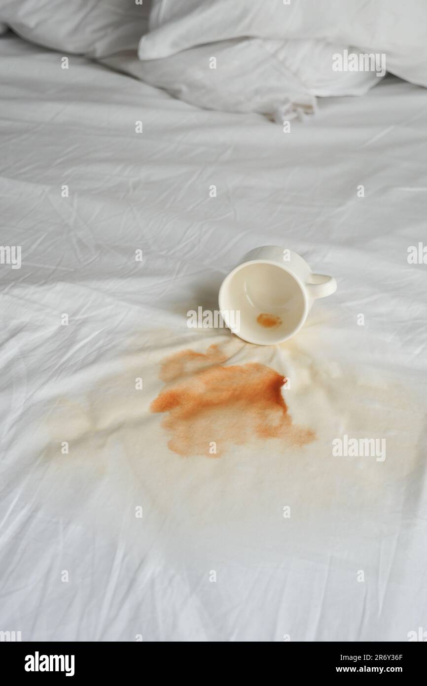 cup of coffee spilled on bed Stock Photo Alamy