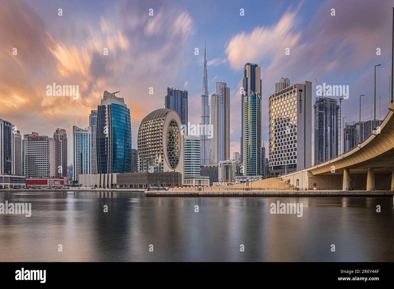 Long exposure at sunset in Dubai. Business center of the city with office buildings and skyscrapers around Burj Khalifa. Financial district skyline Stock Photo