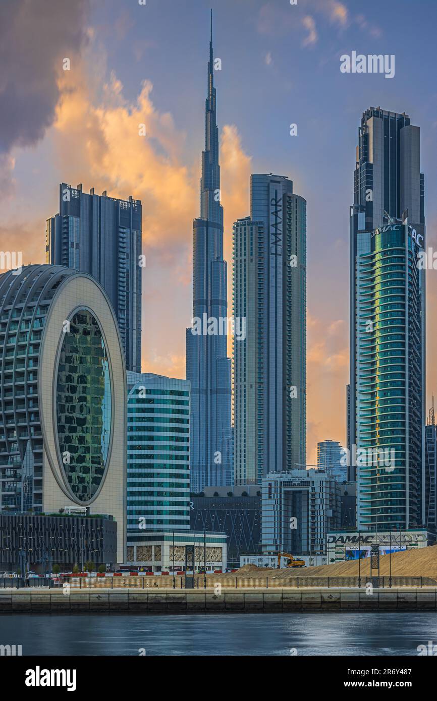Skyscrapers with Burj Khalifa of Dubai. Business and financial center in the city center. Arabic city skyline in the evening. Evening mood with clouds Stock Photo