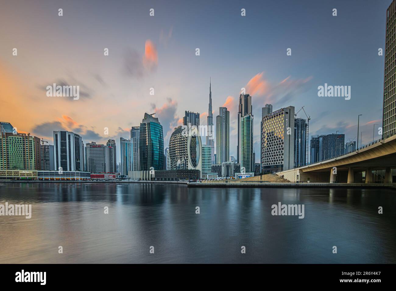 Port entrance in Dubai in the evening. Skyline view. Evening sun with clouds over city skyline of United Arab Emirates. City center with skyscrapers Stock Photo