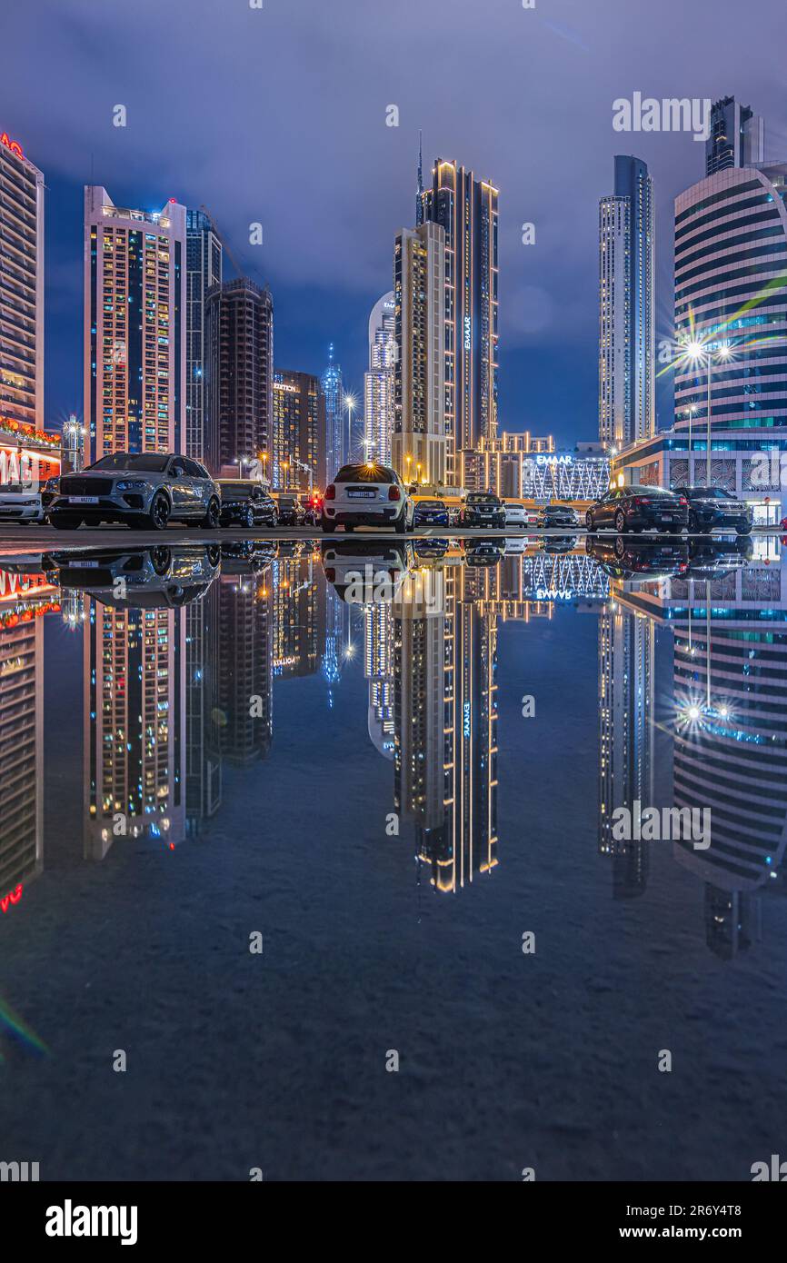 Skyscrapers in the city of Dubai in the United Arab Emirates at night during the blue hour. Reflections of the lighted commercial and office buildings Stock Photo