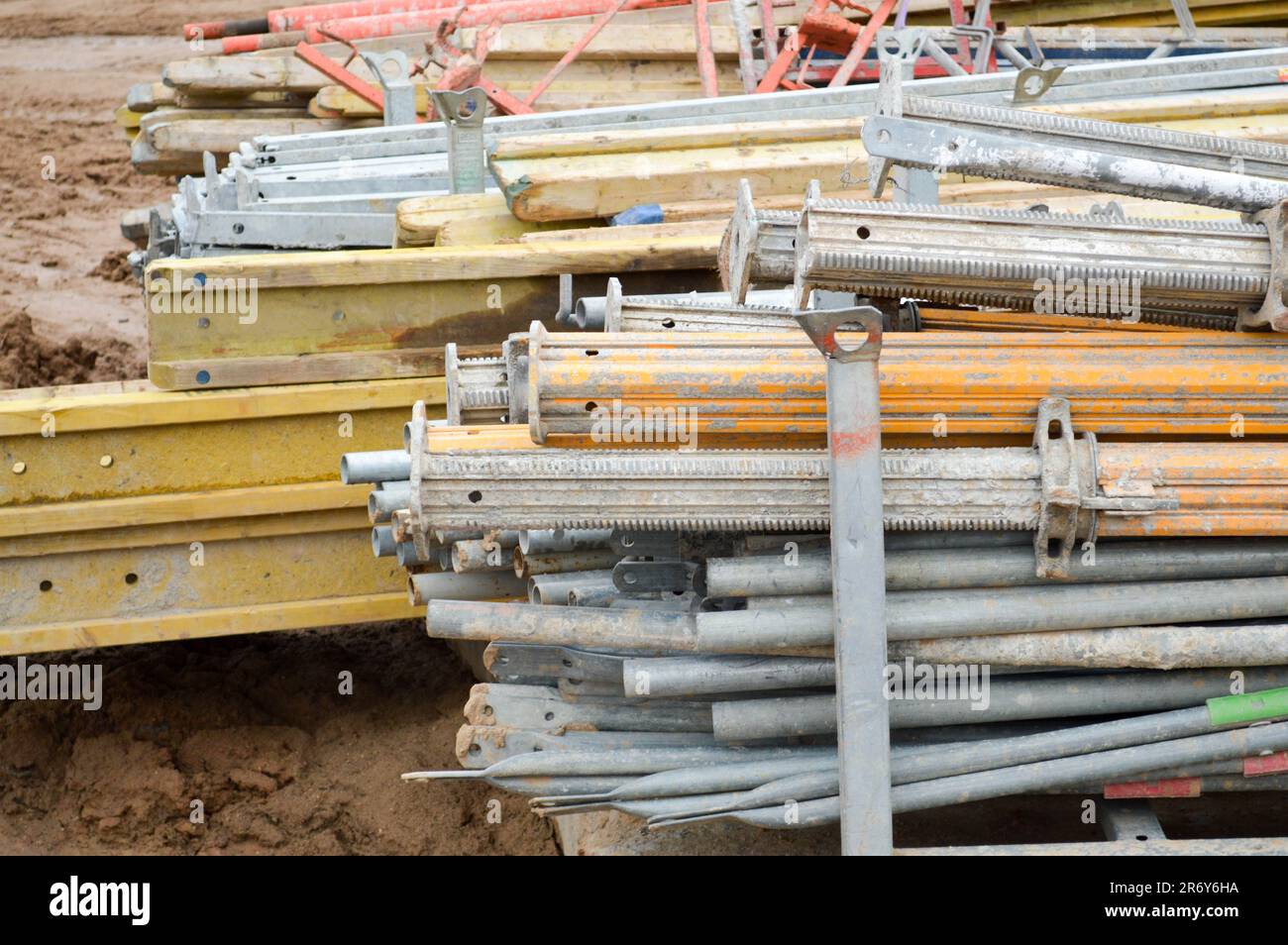 A lot of building materials with metal spare parts, sticks, beams, pipes at an open-air construction site warehouse. Stock Photo