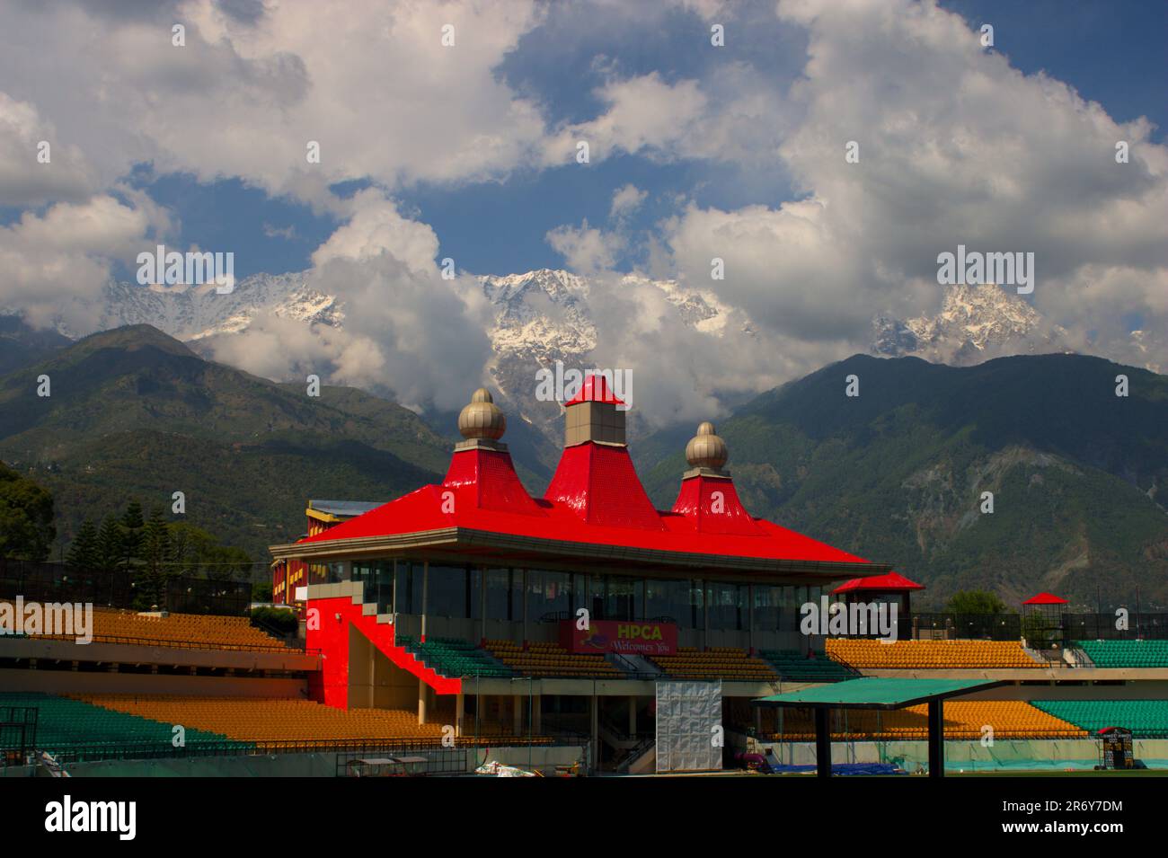 Beautiful and Scenic View of HPCA cricket Stadium and Himalayan Range with heavenly clouds covering them Stock Photo