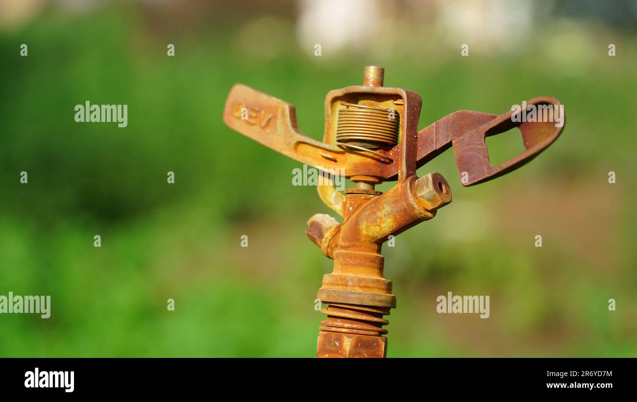 Sprinkler irrigation system installed in the green field. Micro