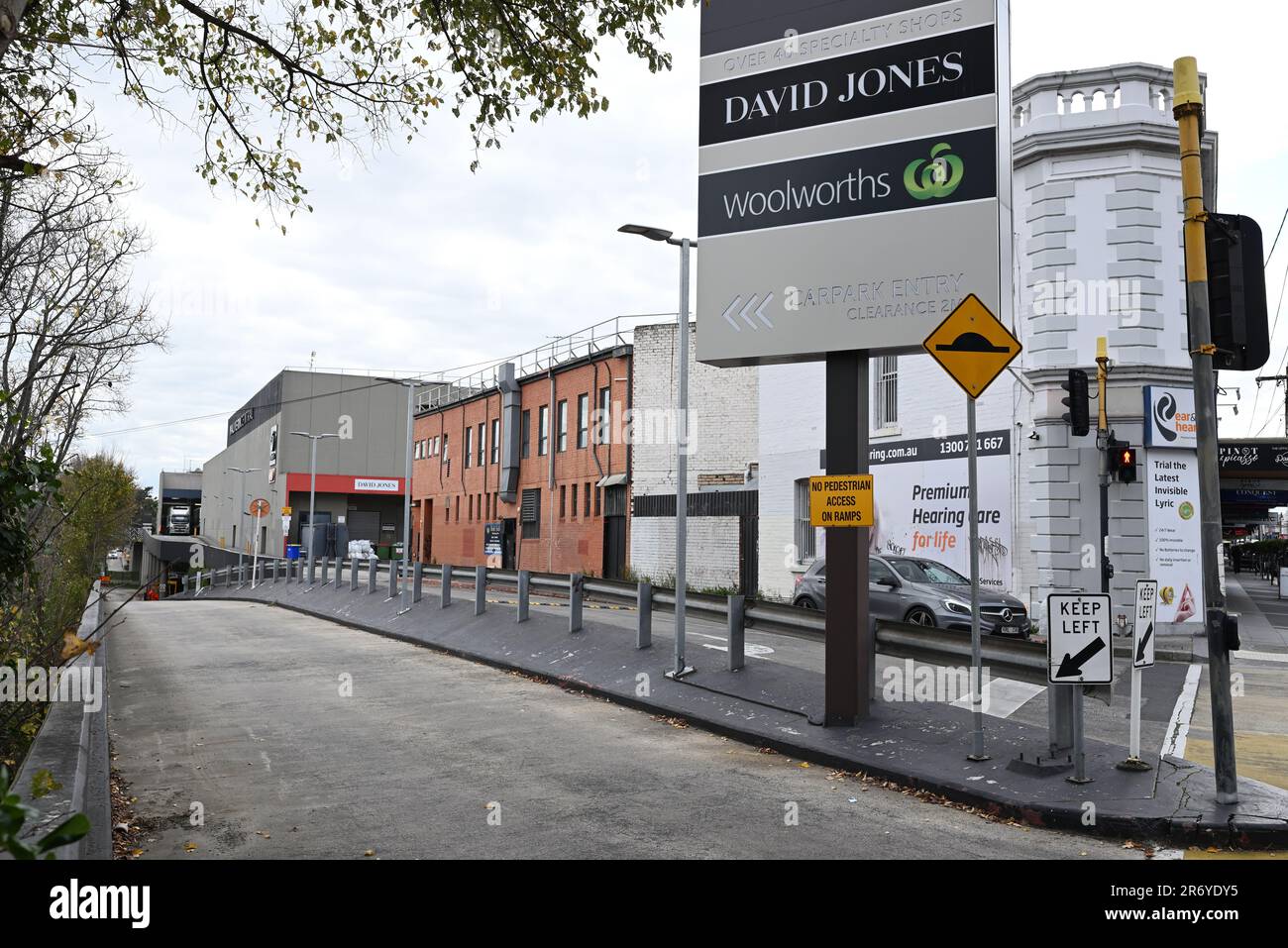 Vehicle entrance to Malvern Central shopping center with shop signage