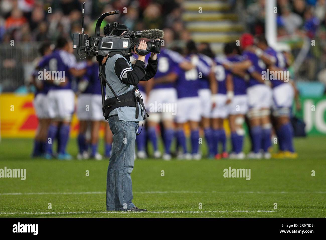 A television camera operator on the field filming the start of the Samoa and South Africa Pool D match of the Rugby World Cup 2011, North Harbour Stadium, Auckland, New Zealand, Friday, September 30, 2011 Stock Photo