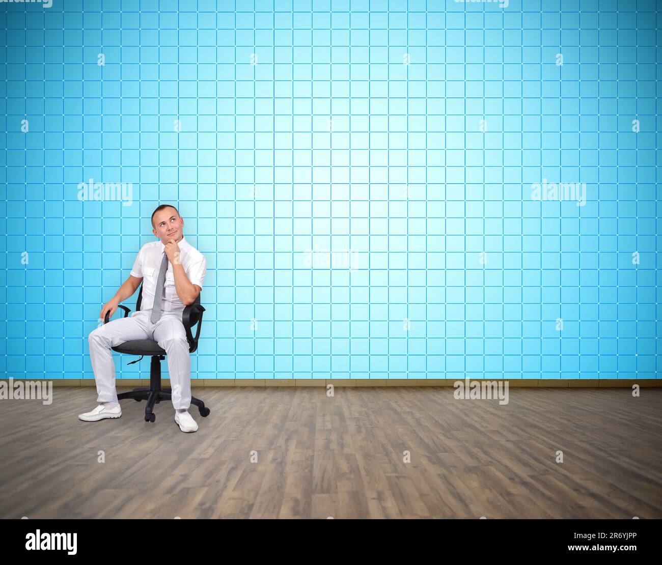 businessman sitting in room with big plasma tv wall Stock Photo
