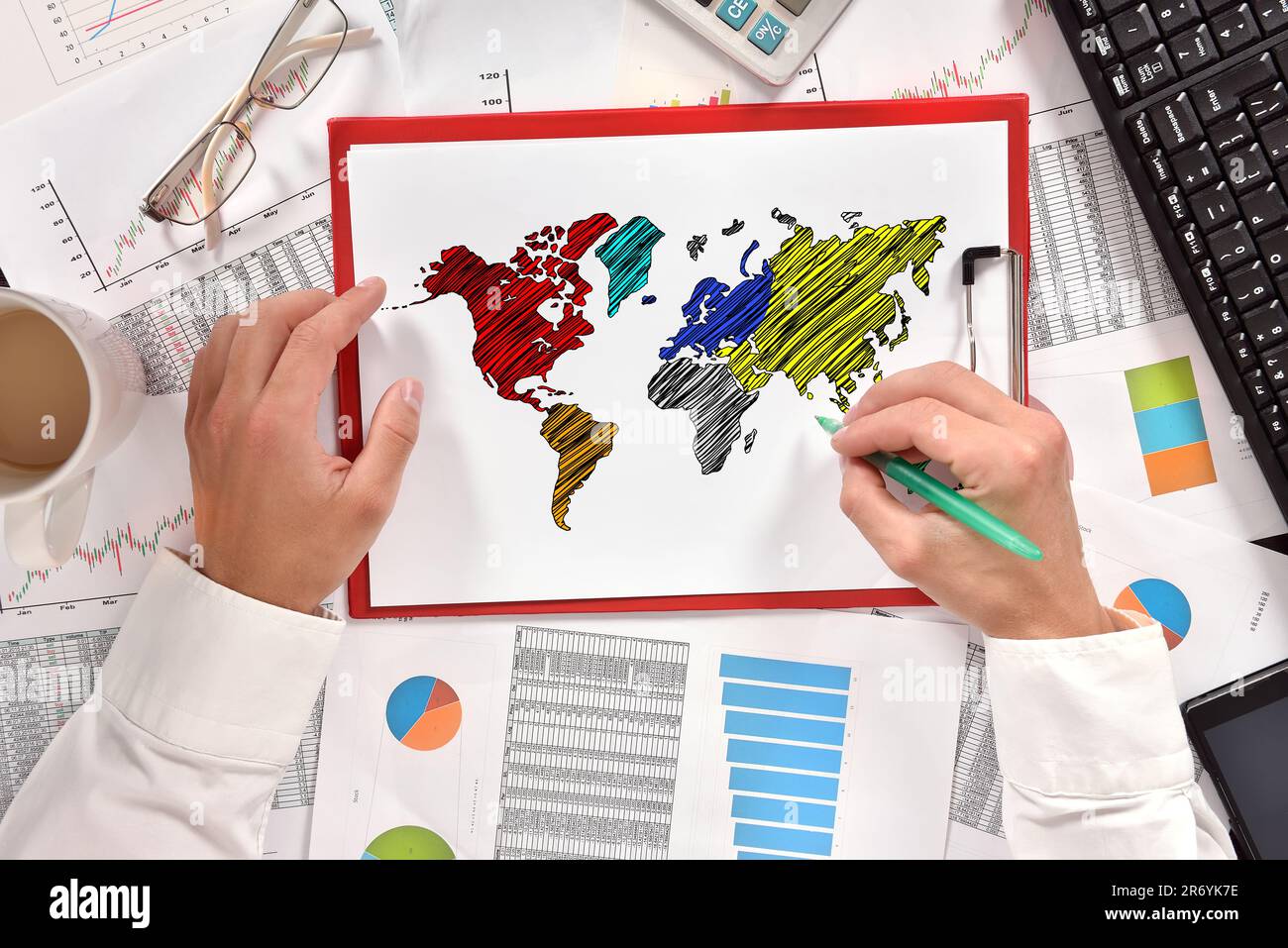 hand businessman drawing world map in clipboard Stock Photo