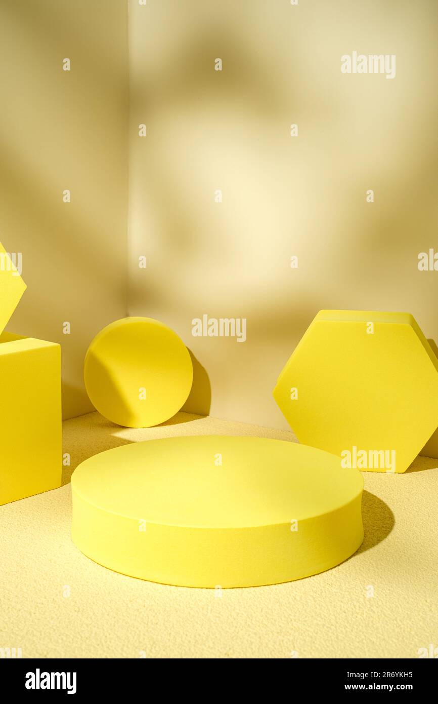 Yellow pedestal product display background with modern geometric block in sunshine light shadow with summer feel Stock Photo