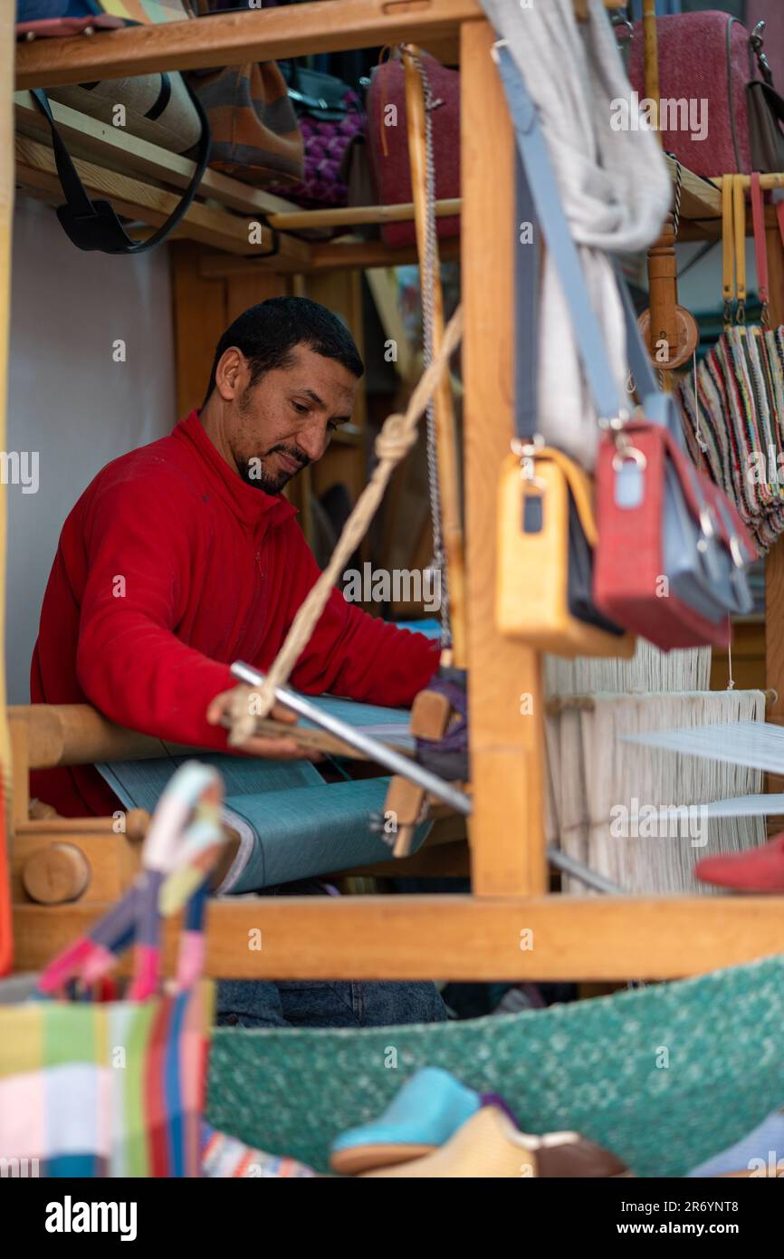 A weaver operating his loom. Stock Photo
