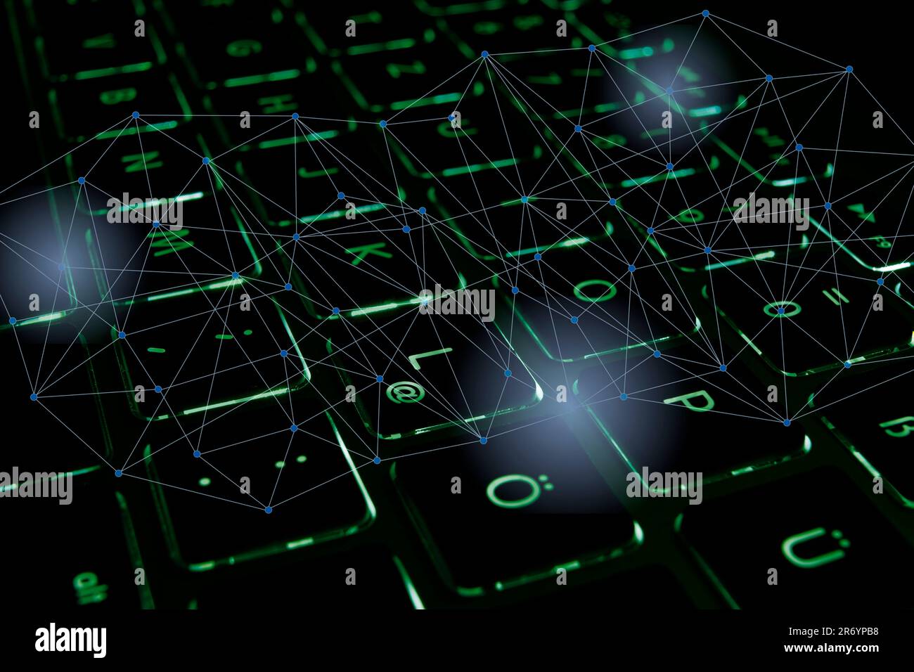 Close-up of a green illuminated computer keyboard with an abstract ...