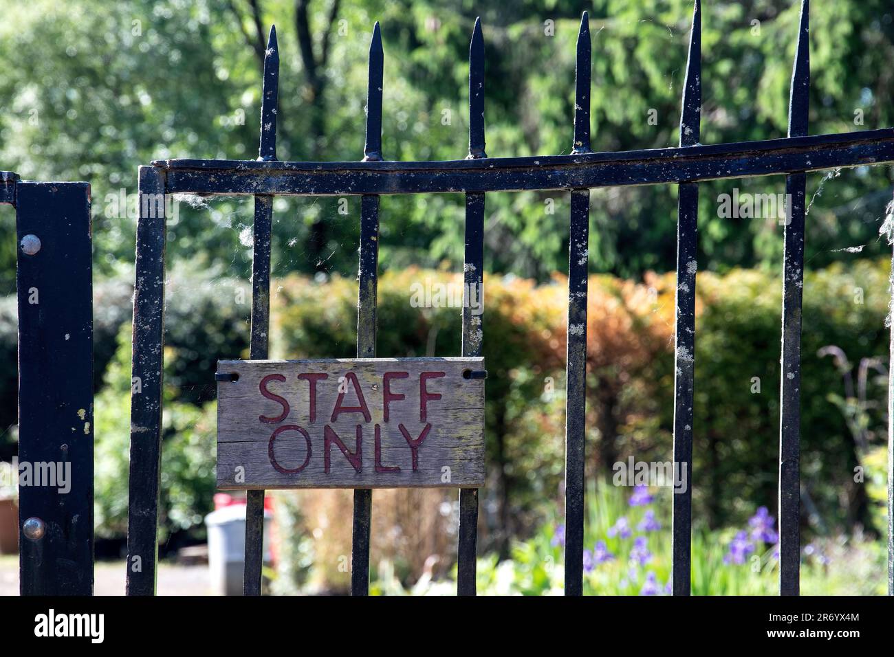 Old staff only wooden sign on an ancient country estate access gate