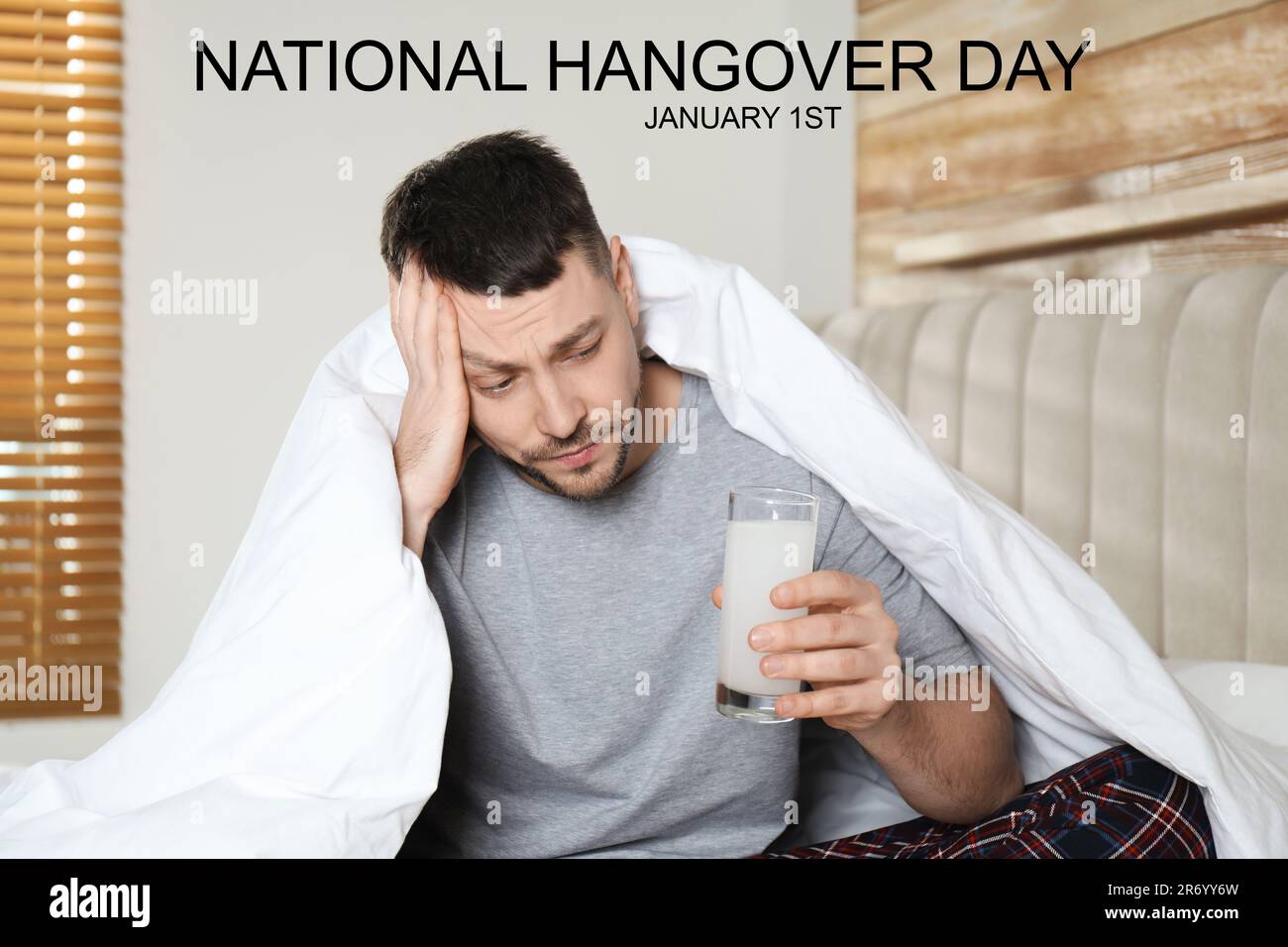 National hangover day - January 1st. Man taking remedy to relieve effects of alcohol consumption at home Stock Photo