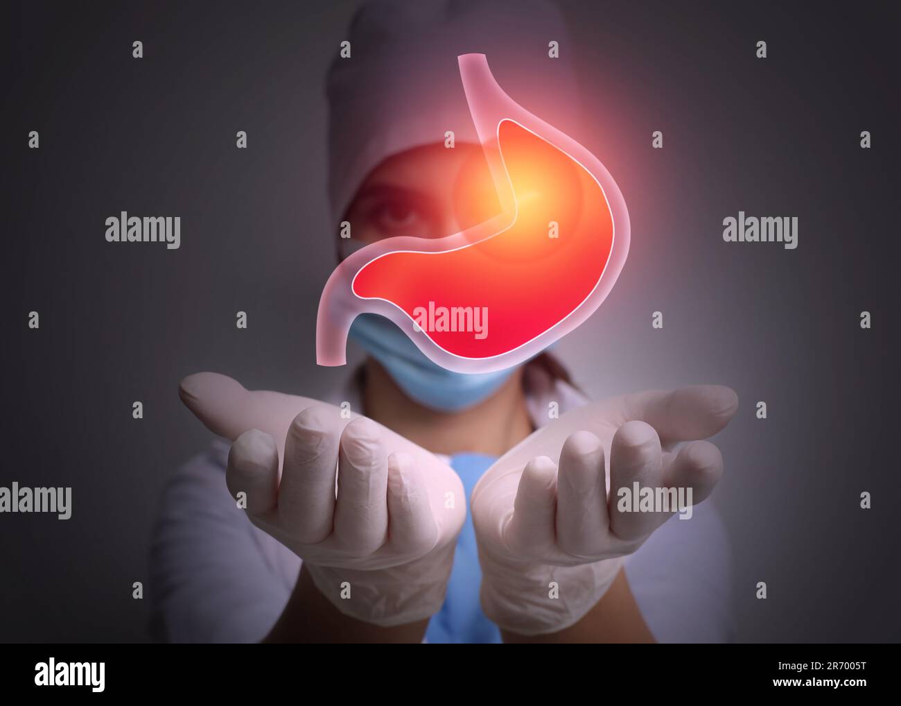 Treatment of heartburn and other gastrointestinal diseases. Doctor holding stomach illustration on dark background, Stock Photo
