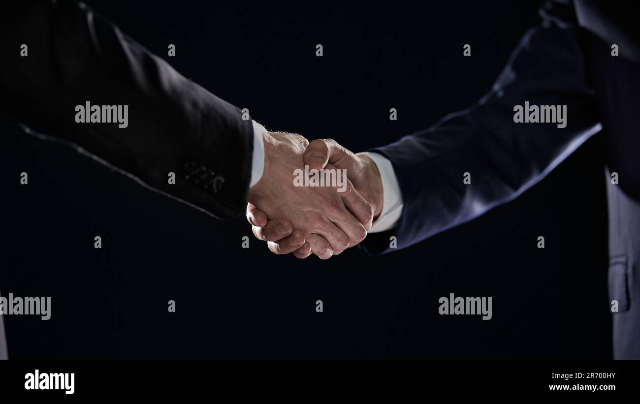 Close-up image of handshake between two colleagues. Stock Photo