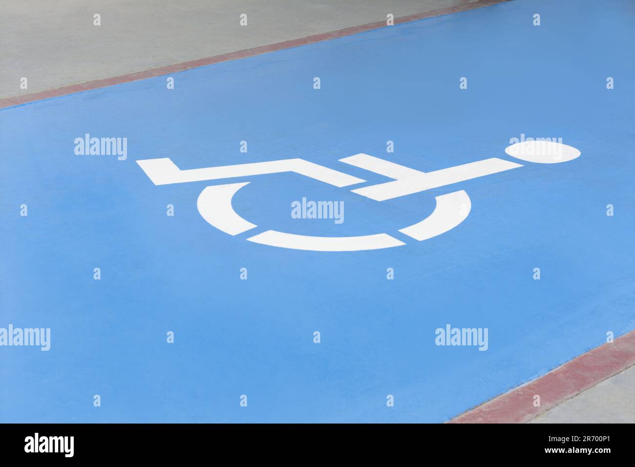 Wheelchair symbol on asphalt road. Disabled parking permit Stock Photo
