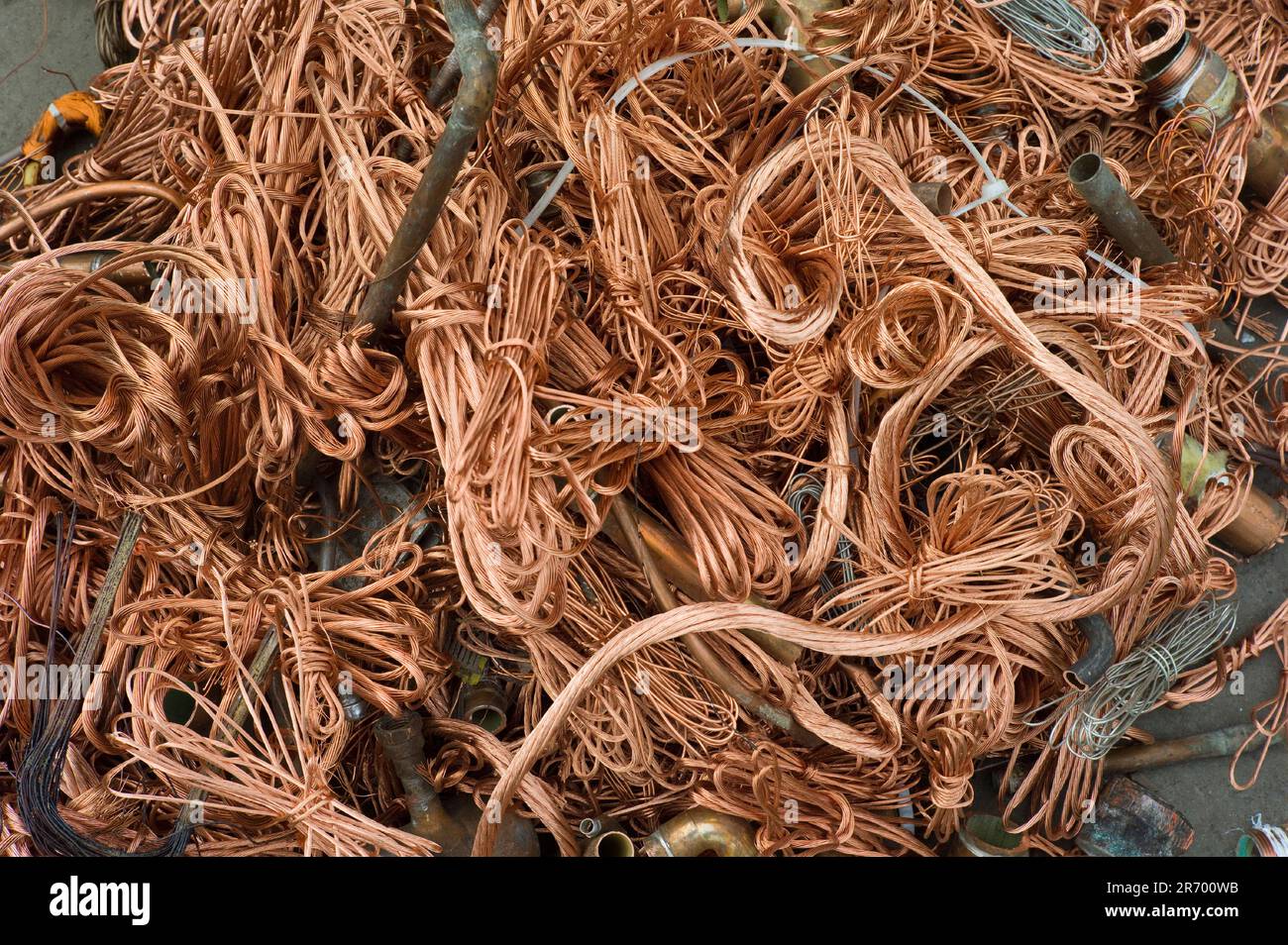 Workers at Atlas Metal & Iron weigh scrap metal for sale on a scale in