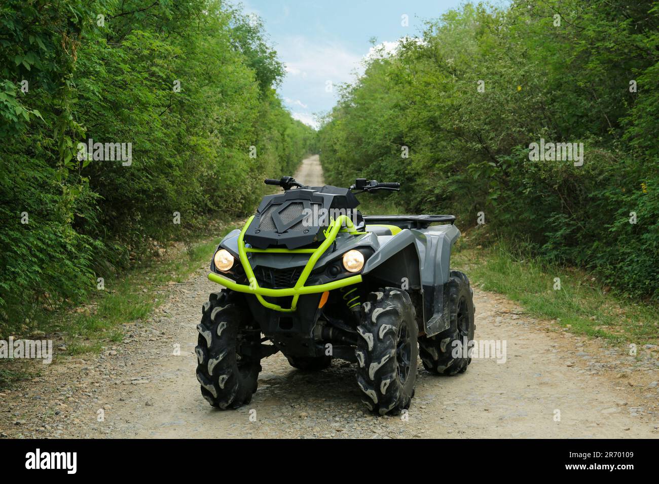 Modern quad bike on pathway near trees outdoors Stock Photo Alamy