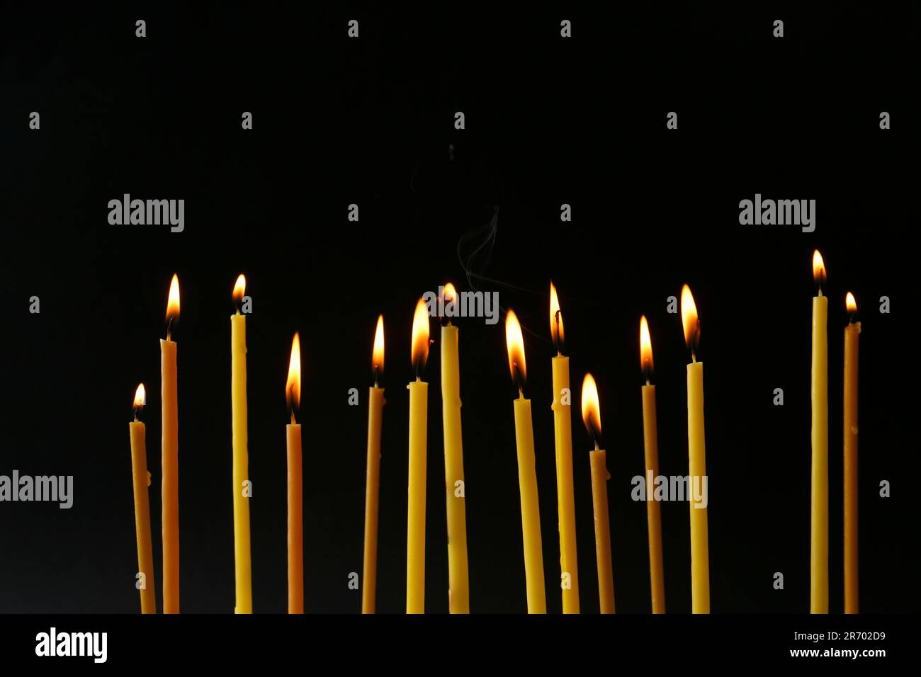 Burning candles on black background. Symbol of sorrow Stock Photo - Alamy