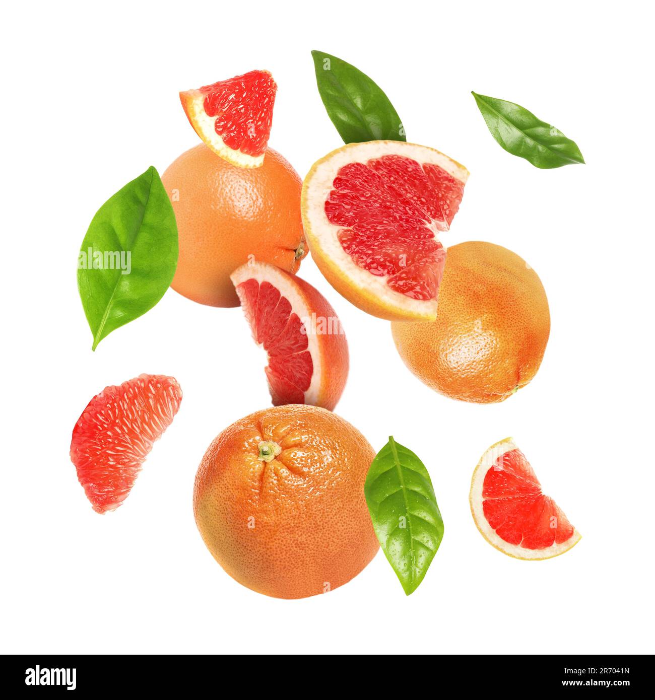 Cut fresh grapefruits and green leaves flying on white background Stock ...