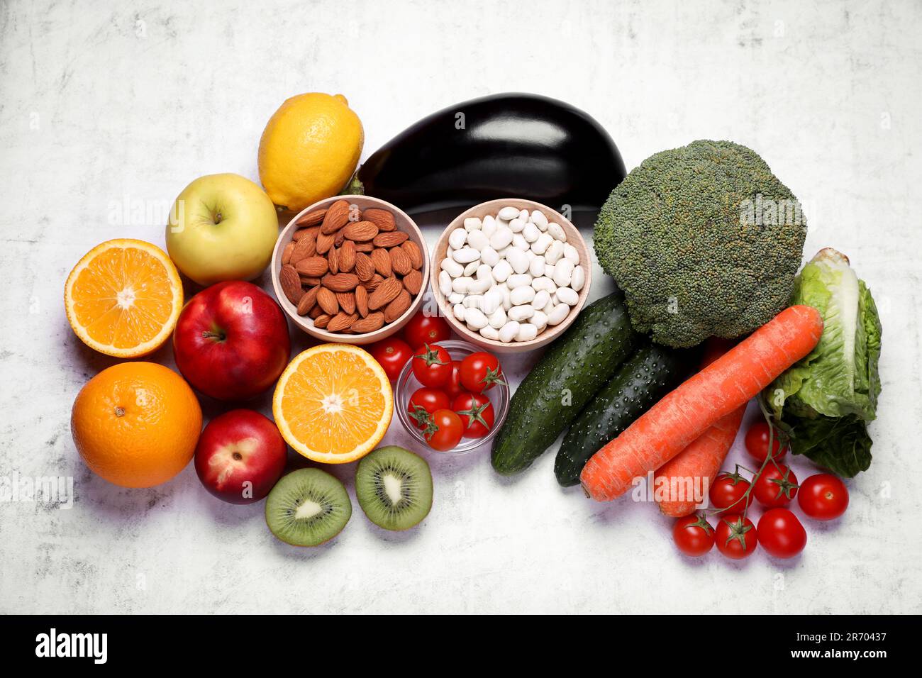 Almonds, beans, fresh fruits and vegetables on light grey textured