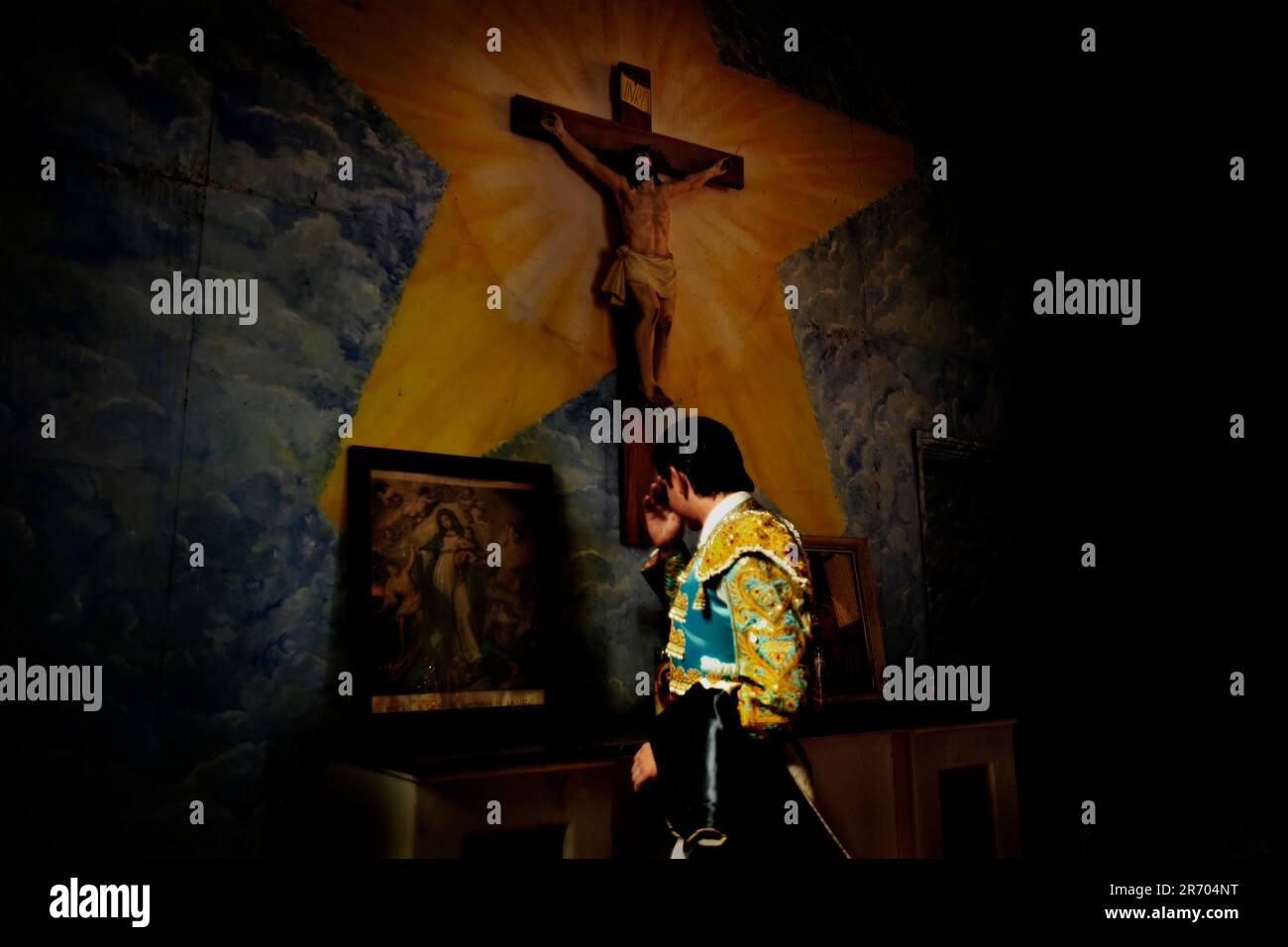 A matador prays for his health in the church at Plaza Monumental, Tijuana, Mexico. Stock Photo