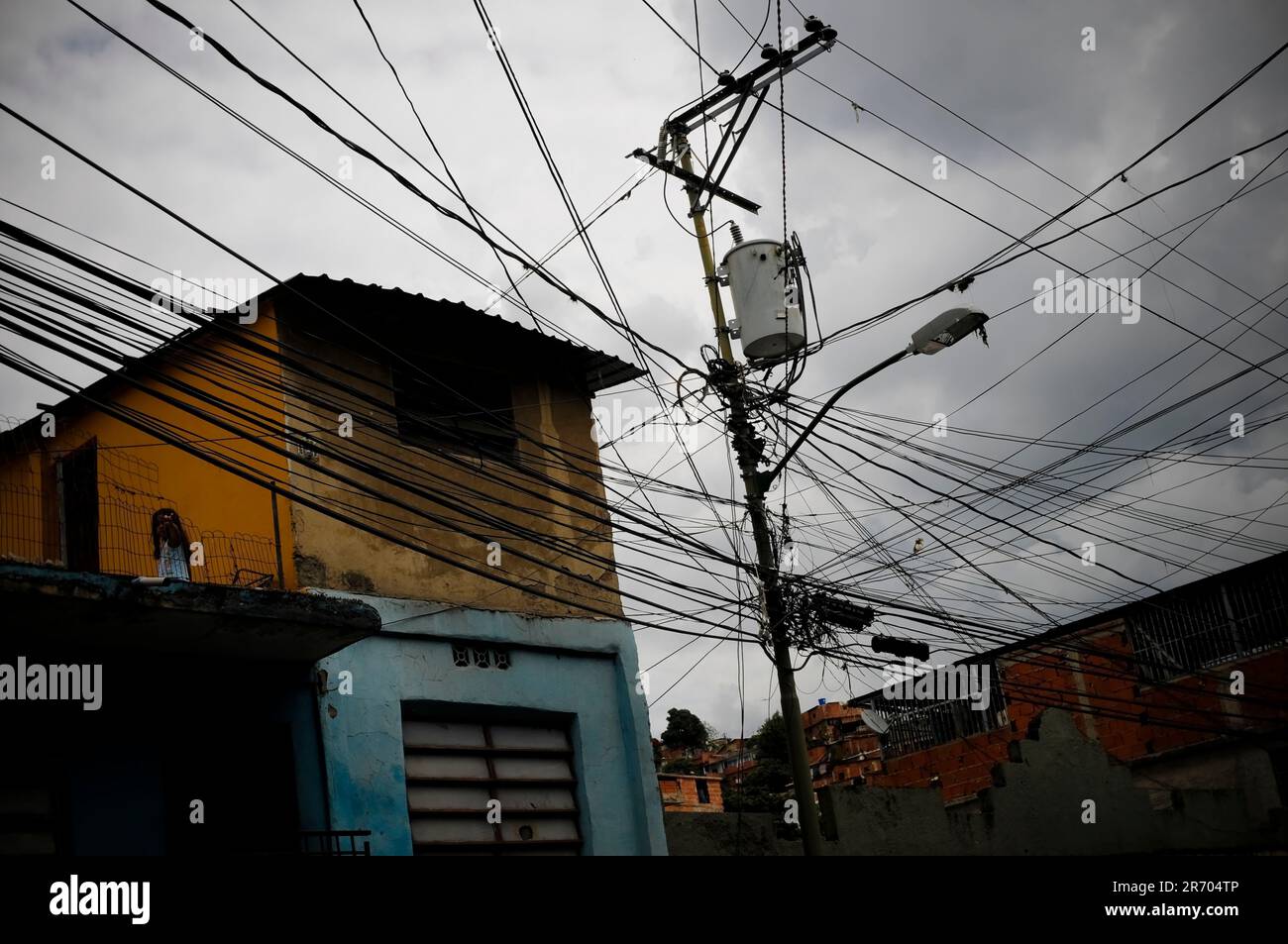 Tangled powerlines in Petare, a slum in Caracas, Venezuela  represent the energy crises causing blackouts across the country. Stock Photo