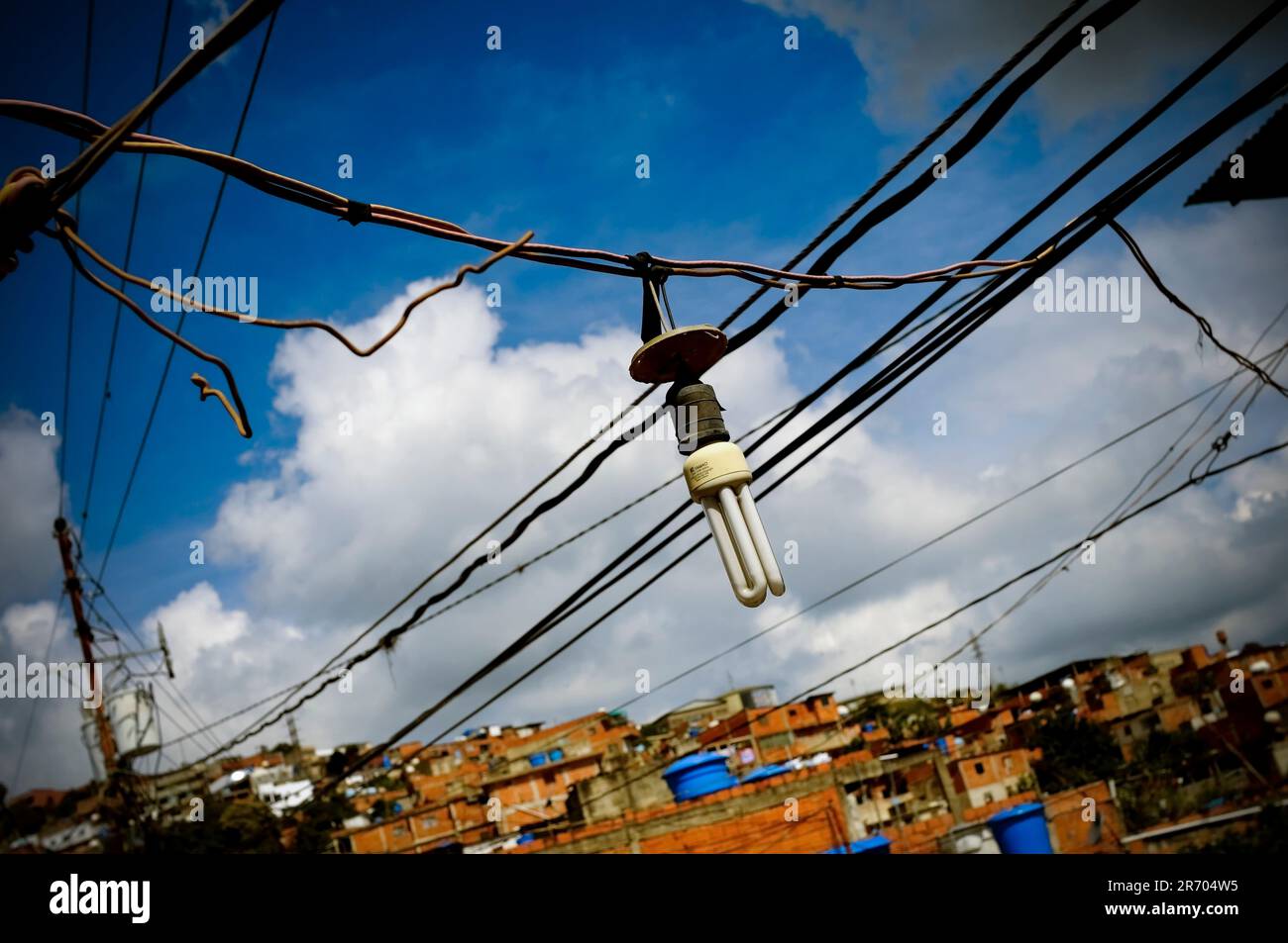 Tangled powerlines in a slum in Caracas, Venezuela  represent the energy crises causing blackouts across the country. Stock Photo