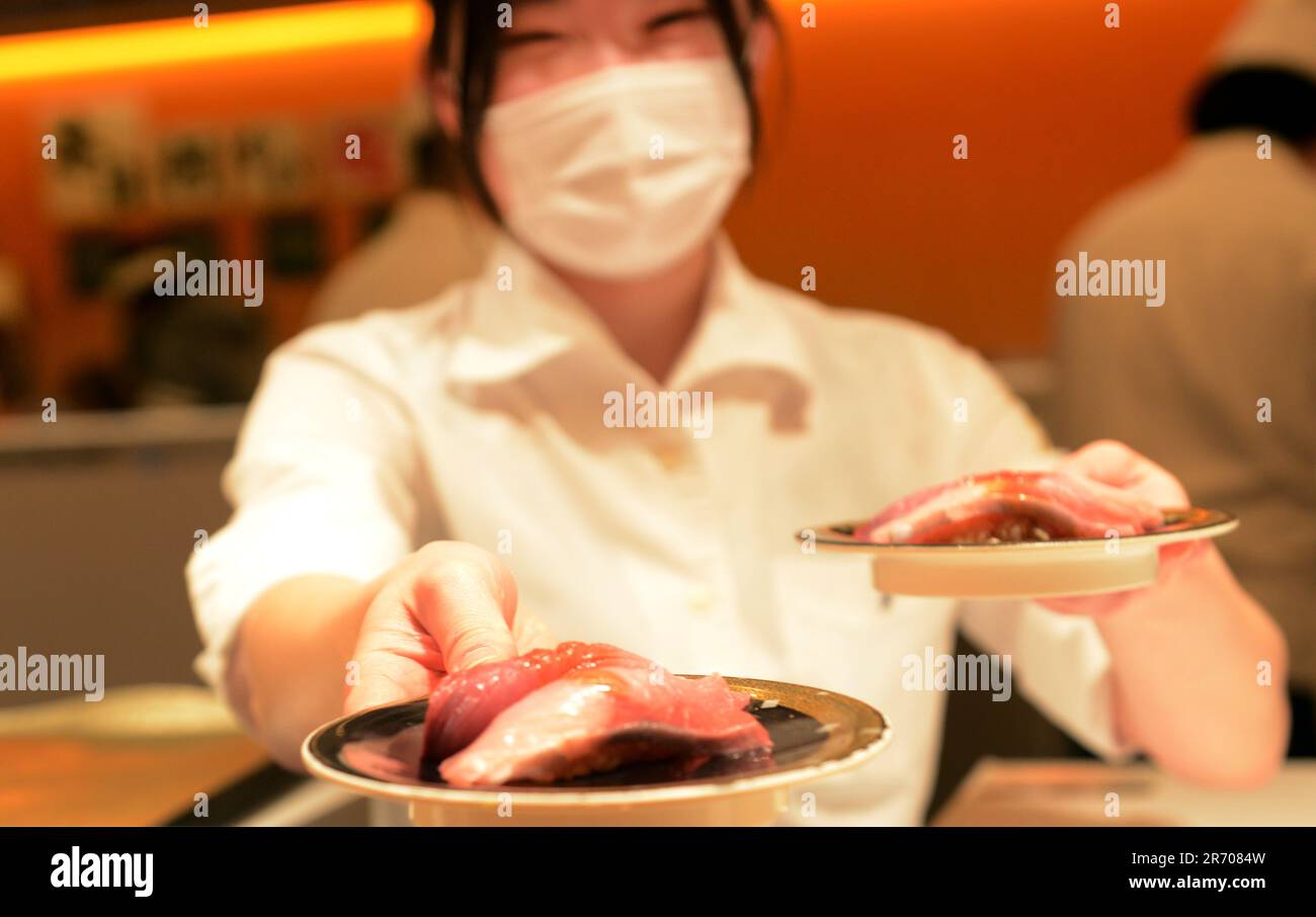 Sitting inside the Kaiten Sushi restaurant in Jingumae, Tokyo, Japan ...