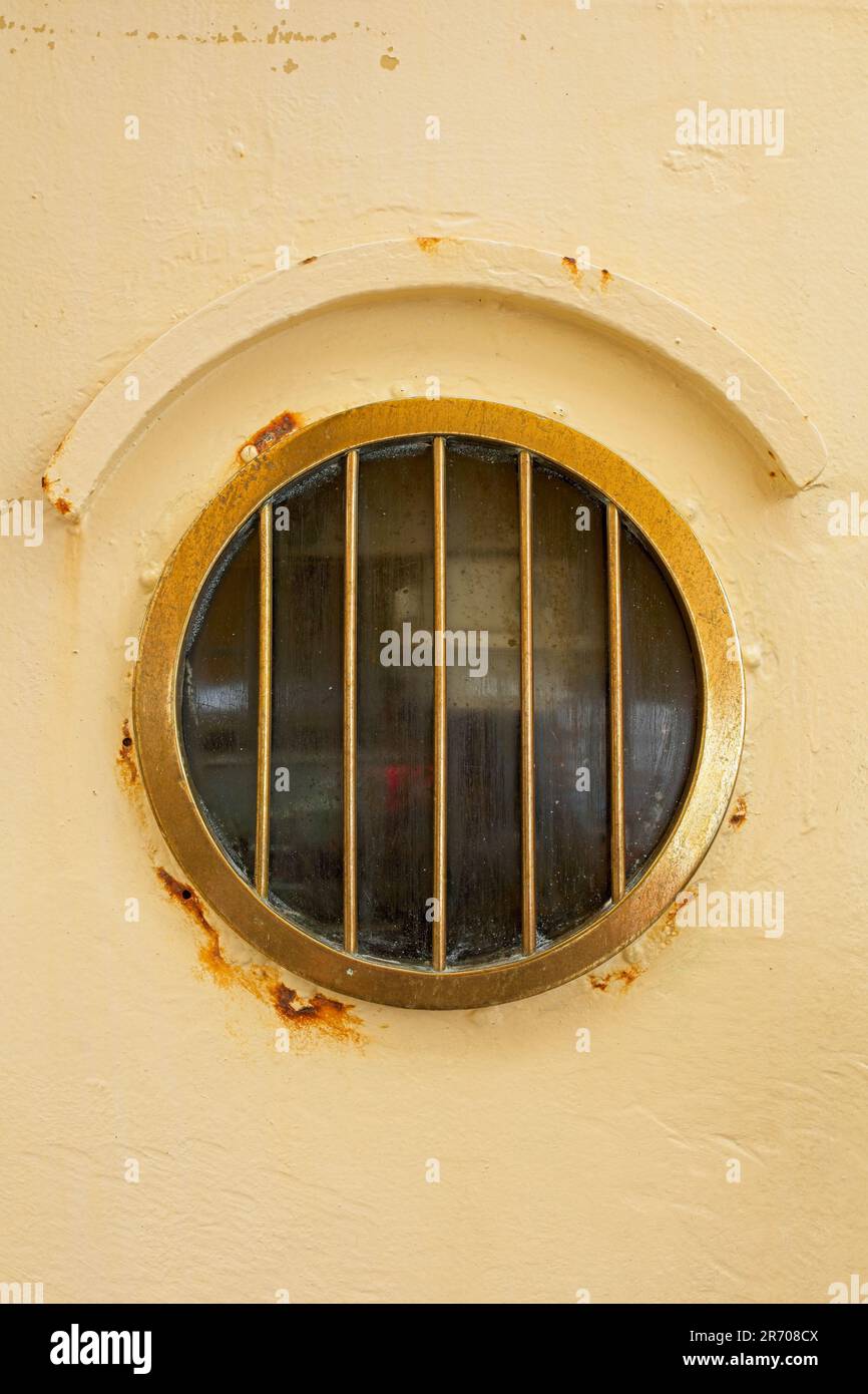 Round porthole window on old ship. Stock Photo