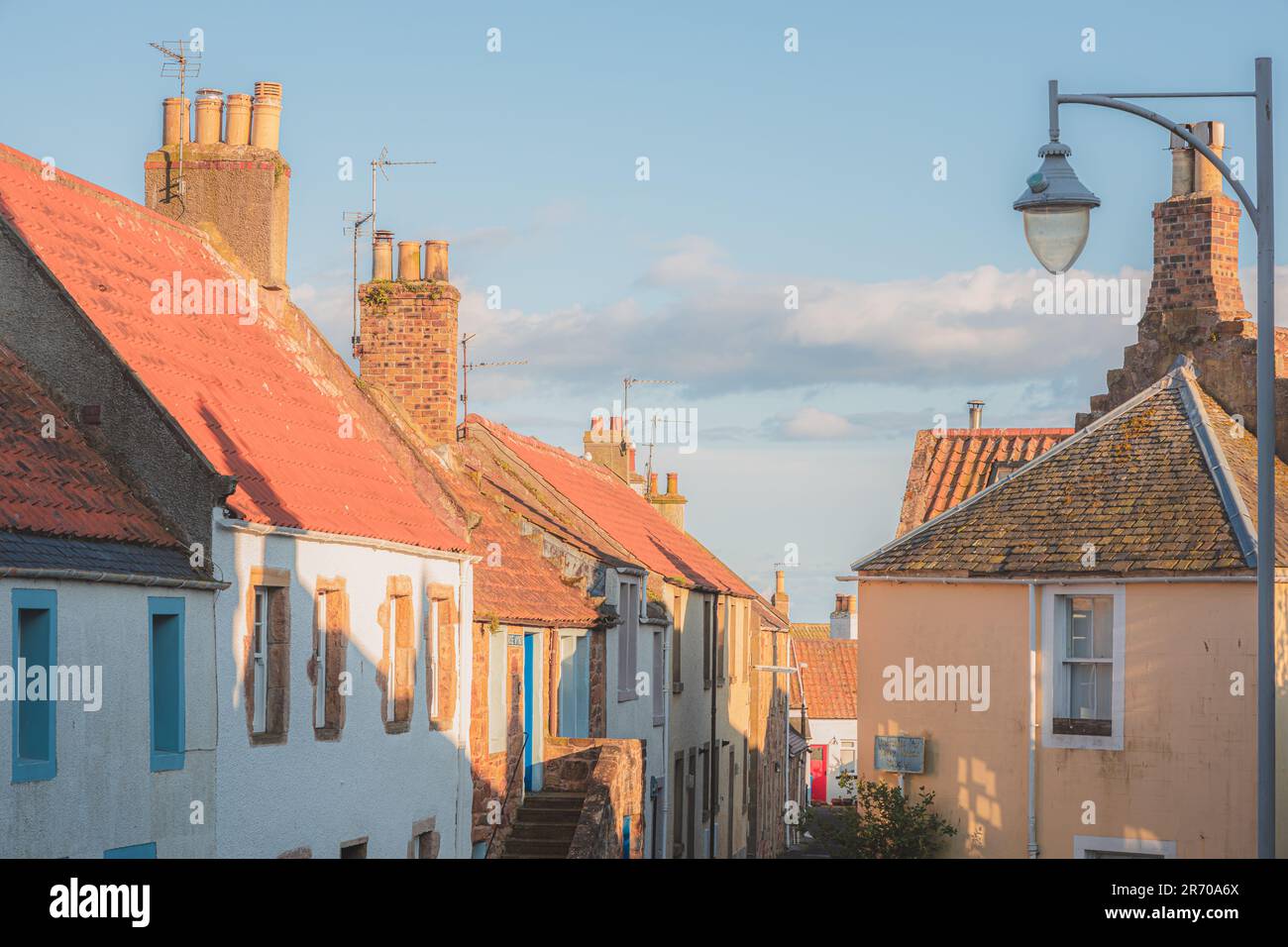 Colourful residential homes along a quiet lane in the quaint and charming old town of the seaside coastal fishing village of Crail, Fife, Scotland, UK Stock Photo