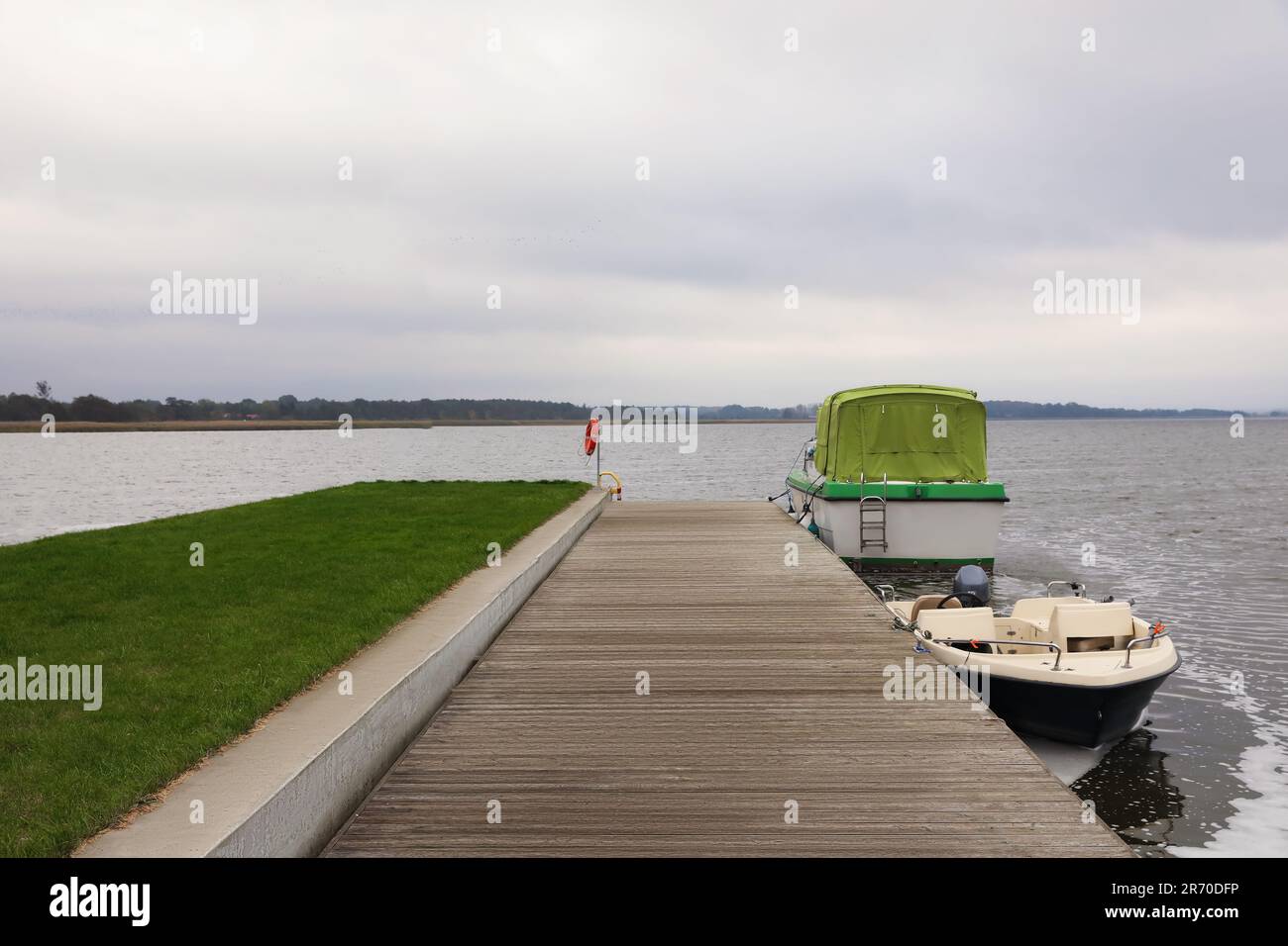 Wooden pier with moored boats near sea. Real estate Stock Photo - Alamy