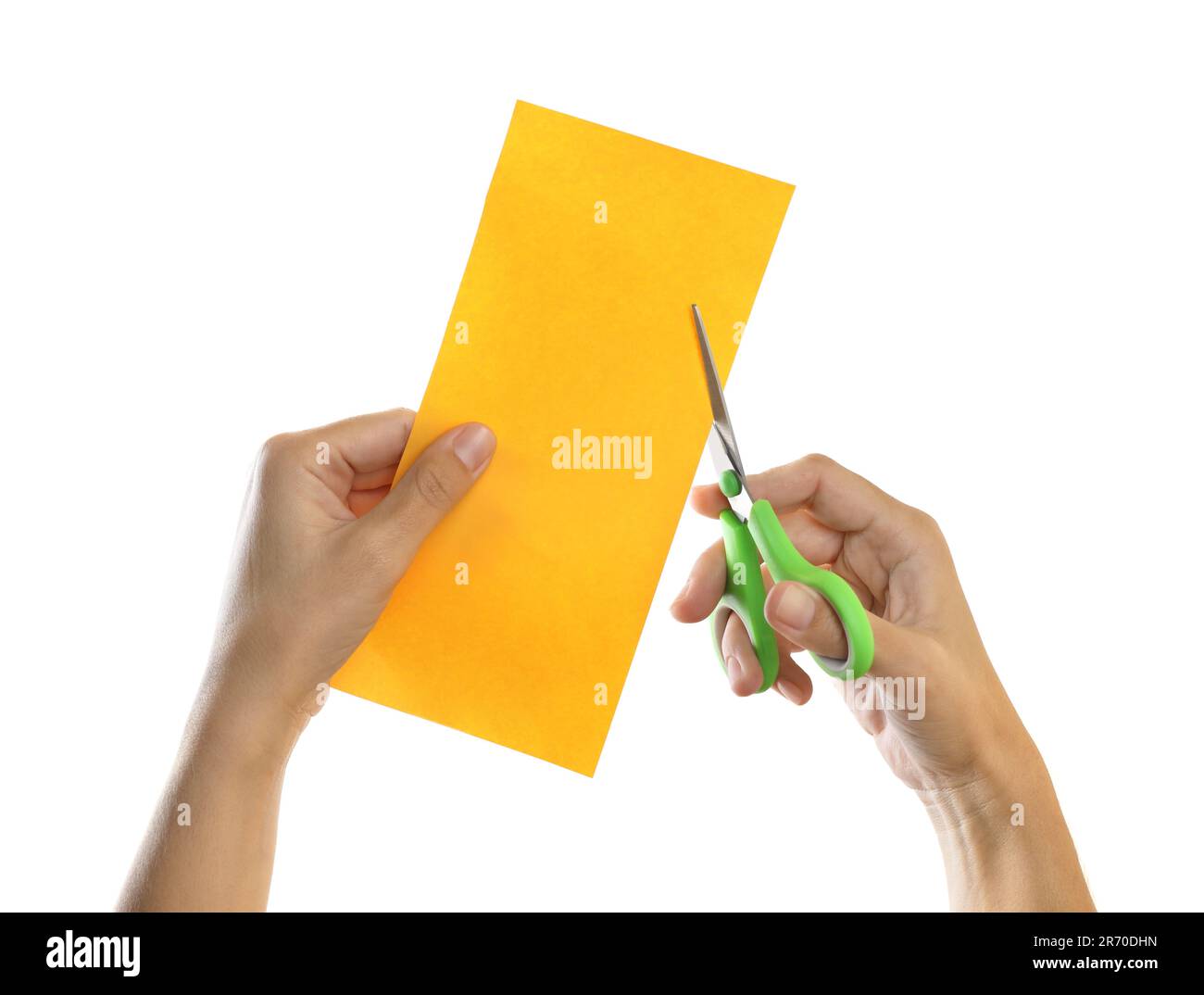 Woman cutting yellow paper with scissors on white background, closeup