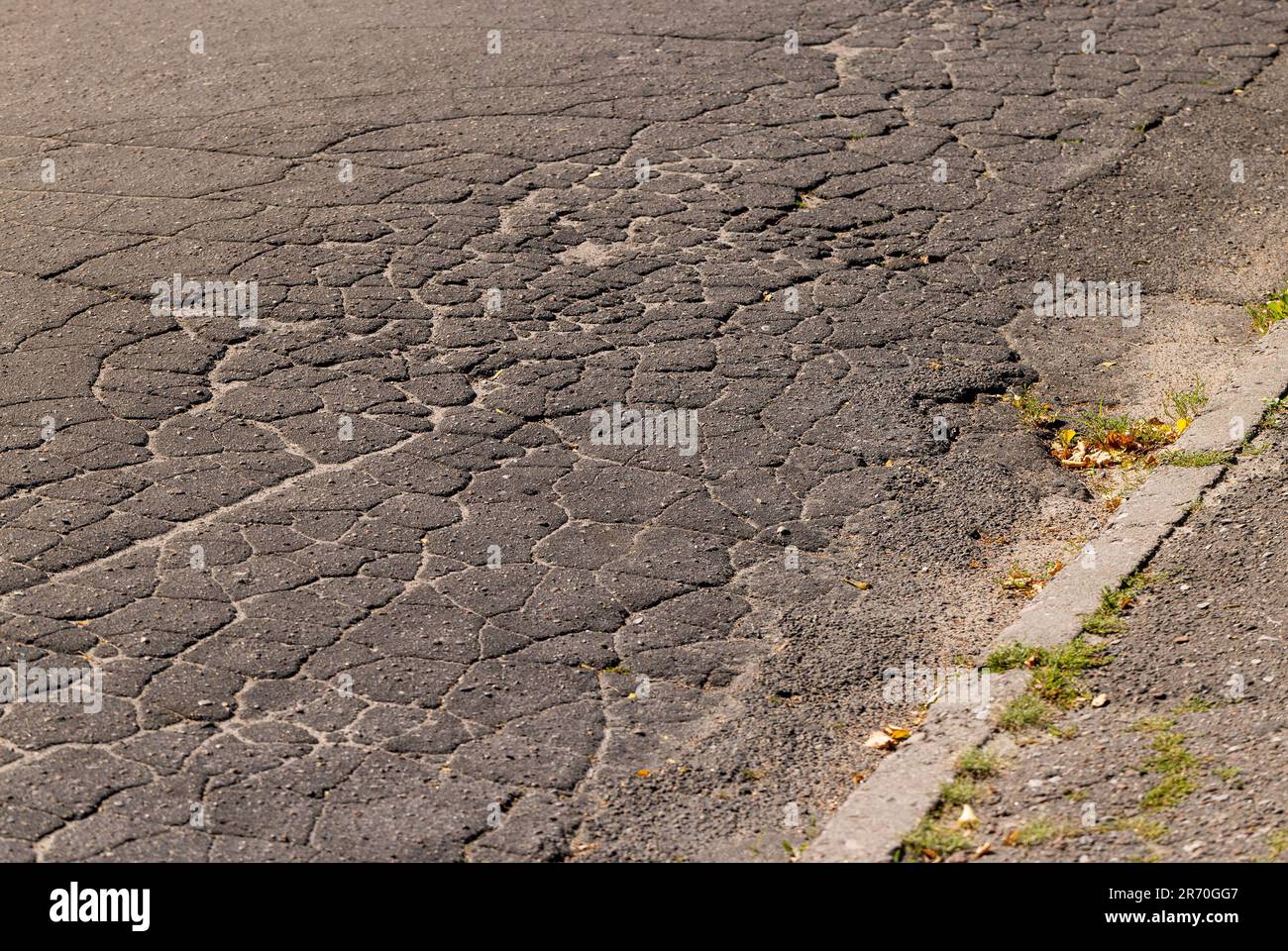 Damaged asphalt pavement , close up of a damaged and defective road