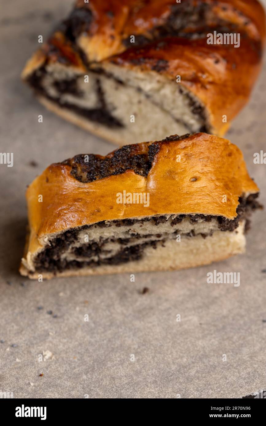 Wheat bun with poppy seed filling, a large amount of sweet poppy seed