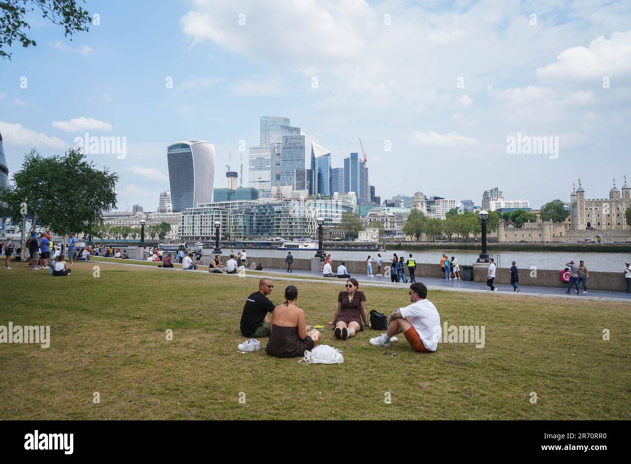 London UK. 12 June 2023 . People relaxing in Potters field park by