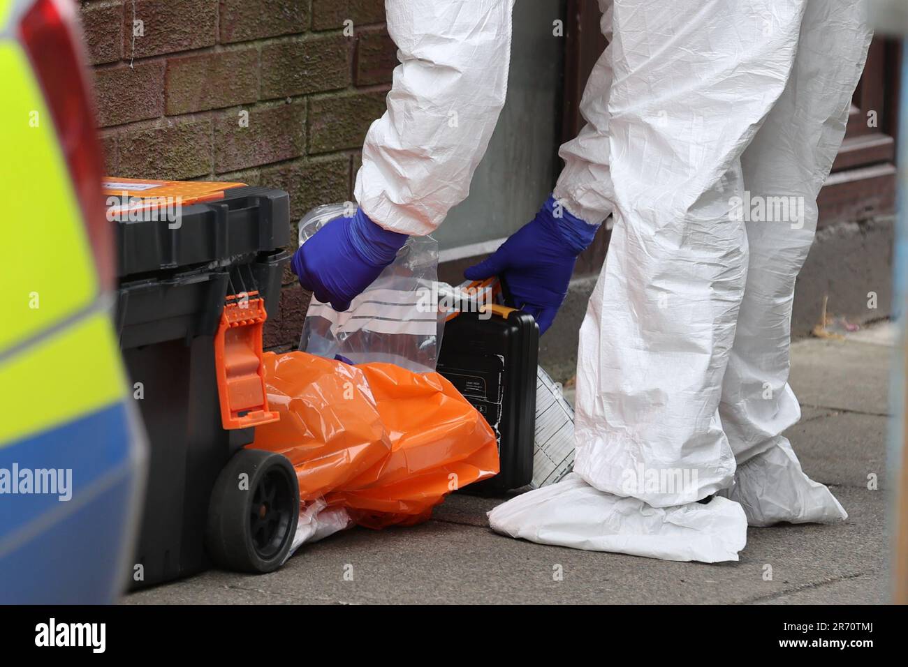 A police forensics officer with evidence bags at a property on James Street in Ballymena, Co Antrim, following the launch of a murder inquiry on Sunday after suspected human remains were found during the search for Chloe Mitchell, who was last seen on CCTV in the early hours of June 3 in Ballymena town centre. Brandon John Rainey, 26, of James Street in Ballymena appeared via video link at Ballymena Magistrates' Court, charged with the murder of 21-year-old Chloe. Picture date: Monday June 12, 2023. Stock Photo