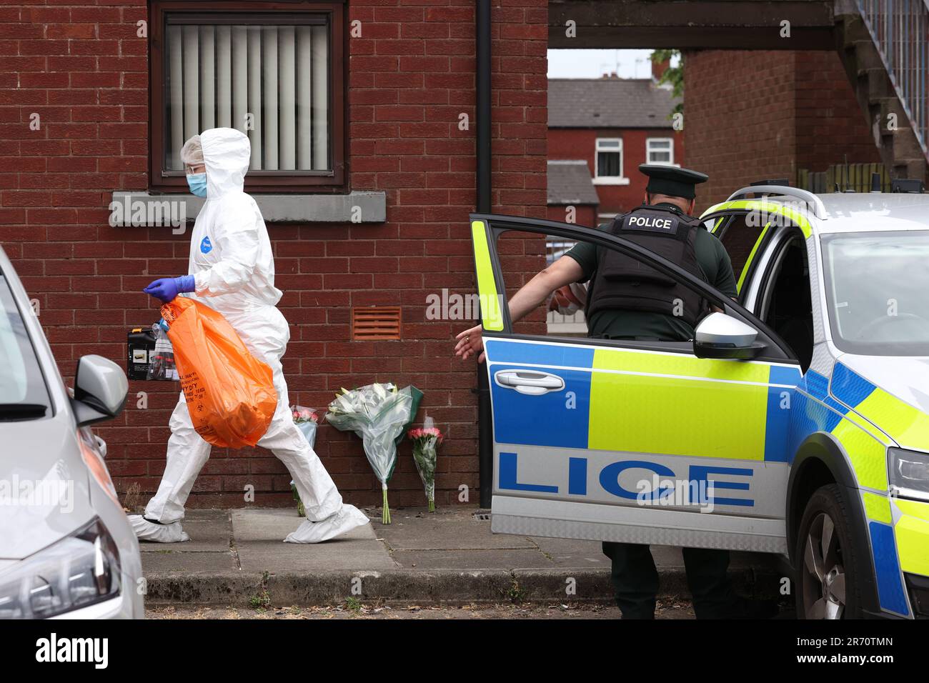 A police forensics officer and a PSNI officer at a property on James Street in Ballymena, Co Antrim, following the launch of a murder inquiry on Sunday after suspected human remains were found during the search for Chloe Mitchell, who was last seen on CCTV in the early hours of June 3 in Ballymena town centre. Brandon John Rainey, 26, of James Street in Ballymena appeared via video link at Ballymena Magistrates' Court, charged with the murder of 21-year-old Chloe. Picture date: Monday June 12, 2023. Stock Photo