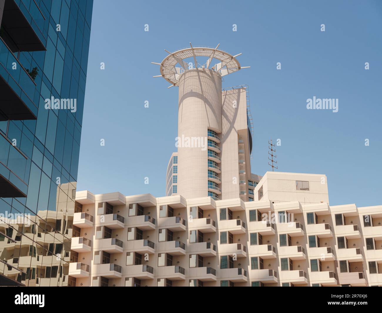 Abu Dhabi, UAE - March 19, 2023: Abu Dhabi Mall and Beach Rotana Hotel. View from the water, of the Beach Rotana Hotel and the Abu Dhabi Mall, with reflections. Stock Photo